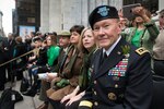 Gen. Martin E. Dempsey, chairman of the Joint Chiefs of Staff, and his wife, Deanie, observe the New York Army Guard "Fighting 69th" unit and other elements of the St. Patricks Day parade in New York City.