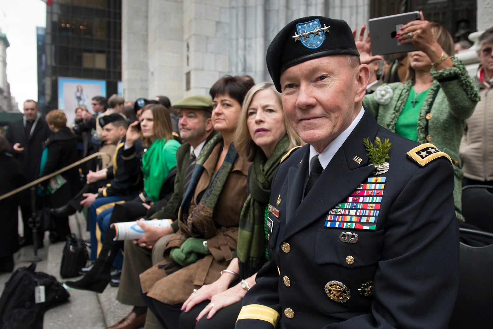 Gen. Martin E. Dempsey, chairman of the Joint Chiefs of Staff, and his wife, Deanie, observe the New York Army Guard "Fighting 69th" unit and other elements of the St. Patricks Day parade in New York City.