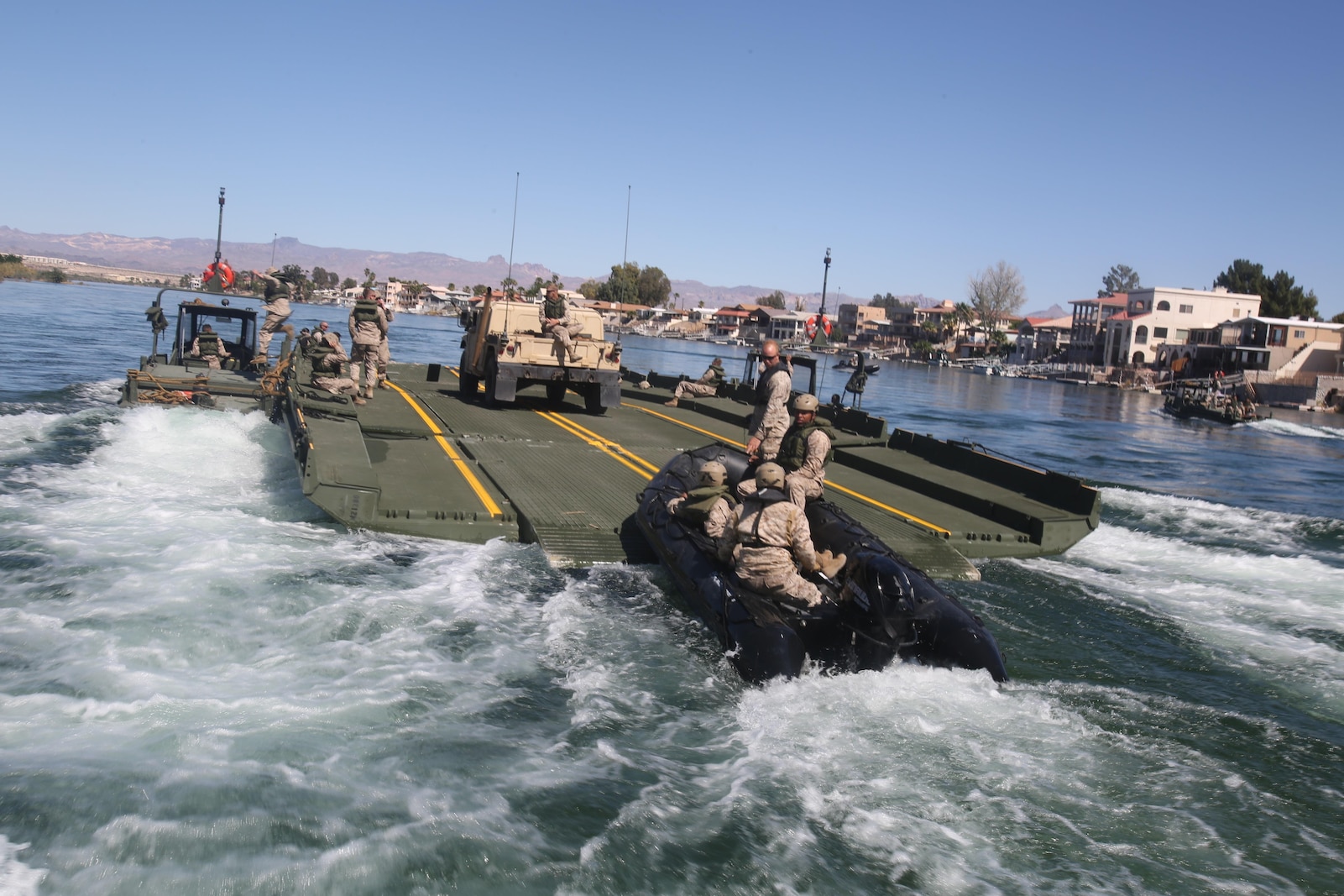 Marines with Bridge Company, 7th Engineer Support Battalion, 1st Marine Logistics Group, drive a Combat Rubber Raiding Craft onto the back of an Improved Ribbon Bridge during a training exercise on the Colorado River in Laughlin, Nev., March 17-21, 2014.  More than 60 Marines trained in moving heavy equipment, to include 7-tons and Humvees, across a flowing body of water using BEBs and an Improved Ribbon Bridge. The IRB is a multi-piece floating bridge that can function as a raft. The BEBs were used to push the raft against the current. Despite being accustomed to training in a bay with little to no current, these Marines managed to transport two 7-tons up the river at the same time.