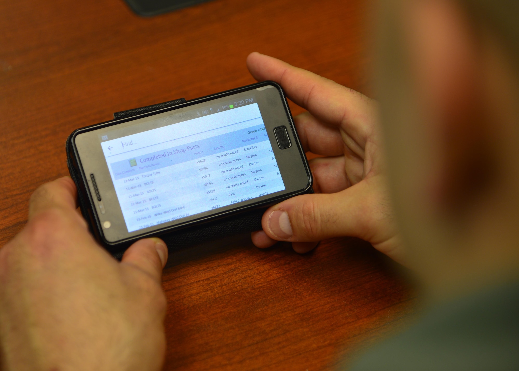 Tech. Sgt. Cory Cuadrado  views a Parts, Inspection, Turnover (PIT) log on his cellphone March 12, 2015, at Dover Air Force Base, Del. PIT was created by Staff Sgt. Chad Ericksen, 436th MXS NDI craftsman, to be a flexible yet accurate data recording program to replace outdated paper logs. Cuadrado is the non-destructive inspection NCO in charge assigned to the 436th Maintenance Squadron. (U.S. Air Force photo/Airman 1st Class William Johnson)