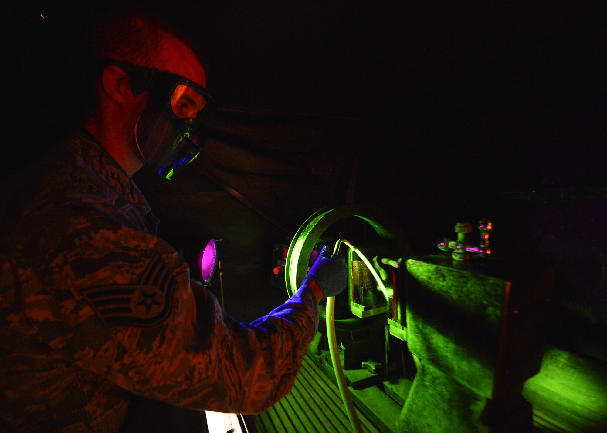 Staff Sgt. Chad Ericksen conducts particle testing on a crane hook March 13, 2014, at Dover Air Force Base, Del. Ericksen reports the findings of his test into the Parts, Inspection, Turnover (PIT) log that he created in 2012 as a way to better record maintenance records within NDI. Ericksen is a non-destructive inspection craftsman assigned to the 436th Maintenance Squadron. (U.S. Air Force photo/Airman 1st Class William Johnson)