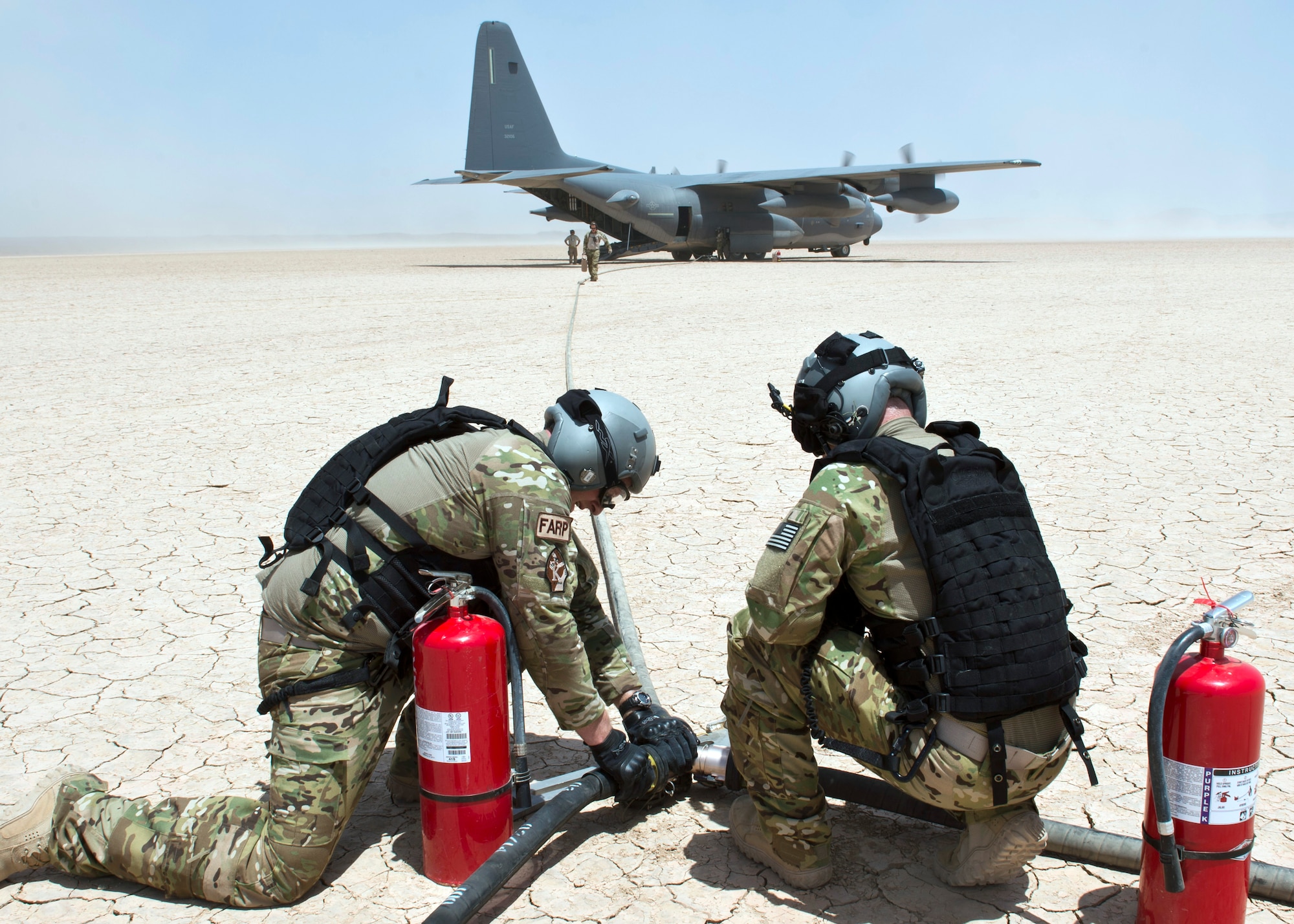 Members from the 81st Expeditionary Rescue Squadron prepare fuel hoses from an HC-130 Combat King as part of a forward arming and refuel point exercise Mar 12, 2015, at Grand Bara, Djibouti. Providing a FARP allowed several smaller airframes to refuel with engines still running, enabling the aircraft to fly missions almost non-stop. (U.S. Air Force photo/Staff Sgt. Kevin Iinuma)
