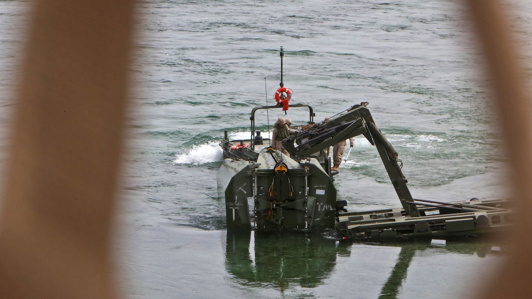 Marines with Bridge Company, 7th Engineer Support Battalion, 1st Marine Logistics Group, secure an Improved Ribbon Bridge, to extract it from the Colorado River, during a training exercise in Laughlin, Nev., March 17-21, 2014. More than 60 Marines trained in moving heavy equipment, to include 7-tons and Humvees, across a flowing body of water using BEBs and an Improved Ribbon Bridge. The IRB is a multi-piece floating bridge that can function as a raft. The BEBs were used to push the raft against the current. Despite being accustomed to training in a bay with little to no current, these Marines managed to transport two 7-tons up the river at the same time.