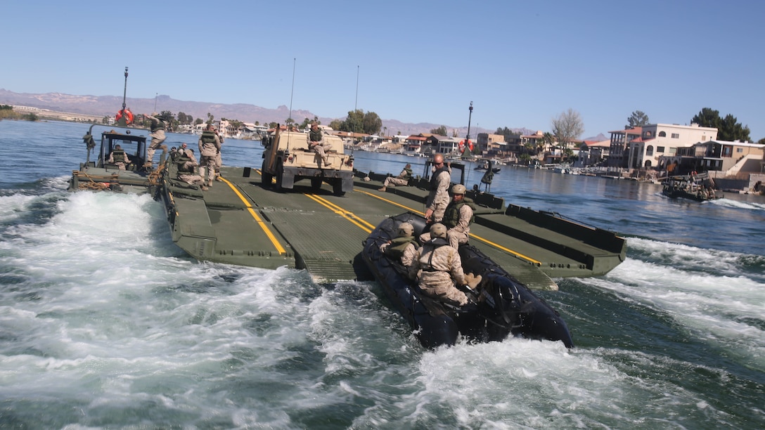 Marines with Bridge Company, 7th Engineer Support Battalion, 1st Marine Logistics Group, drive a Combat Rubber Raiding Craft onto the back of an Improved Ribbon Bridge during a training exercise on the Colorado River in Laughlin, Nev., March 17-21, 2014.  More than 60 Marines trained in moving heavy equipment, to include 7-tons and Humvees, across a flowing body of water using BEBs and an Improved Ribbon Bridge. The IRB is a multi-piece floating bridge that can function as a raft. The BEBs were used to push the raft against the current. Despite being accustomed to training in a bay with little to no current, these Marines managed to transport two 7-tons up the river at the same time.