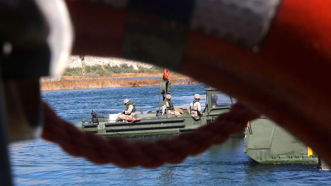 Marines with Bridge Company, 7th Engineer Support Battalion, 1st Marine Logistics Group, push an Improved Ribbon Bridge against the current of the Colorado River during a rafting exercise aboard Laughlin, Nev., March 17-21, 2014. More than 60 Marines trained in moving heavy equipment, to include 7-tons and Humvees, across a flowing body of water using BEBs and an Improved Ribbon Bridge. The IRB is a multi-piece floating bridge that can function as a raft. The BEBs were used to push the raft against the current. Despite being accustomed to training in a bay with little to no current, these Marines managed to transport two 7-tons up the river at the same time.