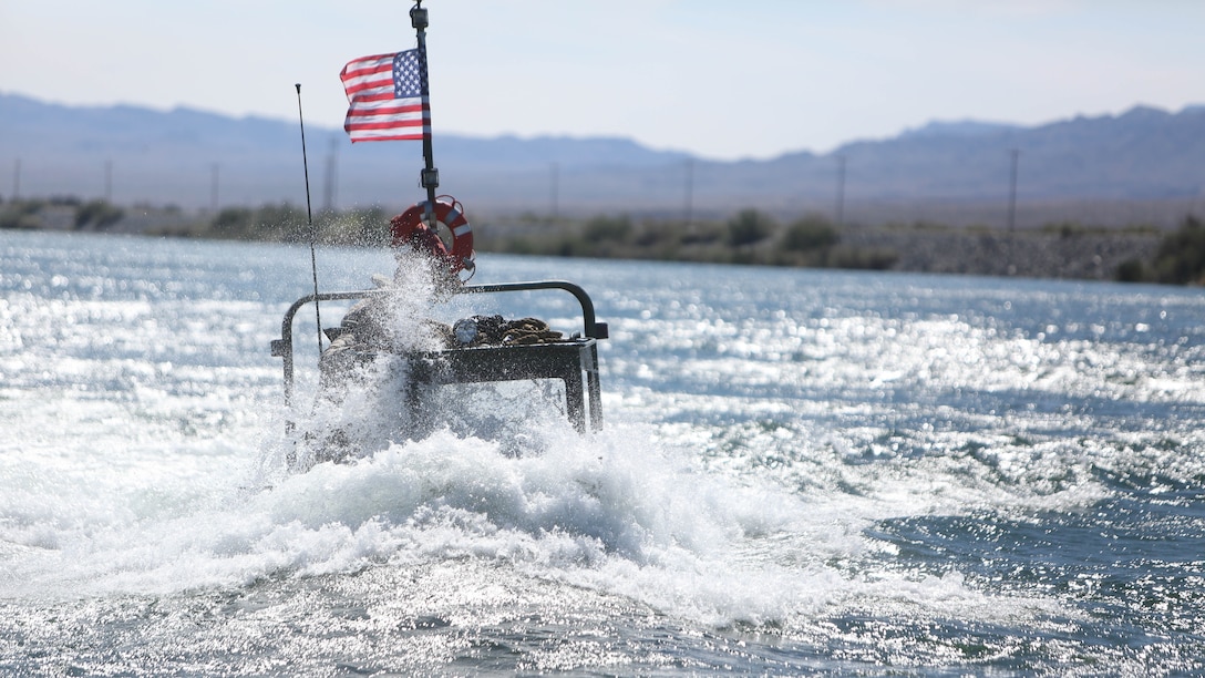 A Bridge Erection Boat faces the current of the Colorado River during a training exercise executed by Marines with Bridge Company, 7th Engineer Support Battalion, 1st Marine Logistics Group, in Laughlin, Nev., March 17-21, 2014. More than 60 Marines trained in moving heavy equipment, to include 7-tons and Humvees, across a flowing body of water using BEBs and an Improved Ribbon Bridge. The IRB is a multi-piece floating bridge that can function as a raft. The BEBs were used to push the raft against the current. Despite being accustomed to training in a bay with little to no current, these Marines managed to transport two 7-tons up the river at the same time.