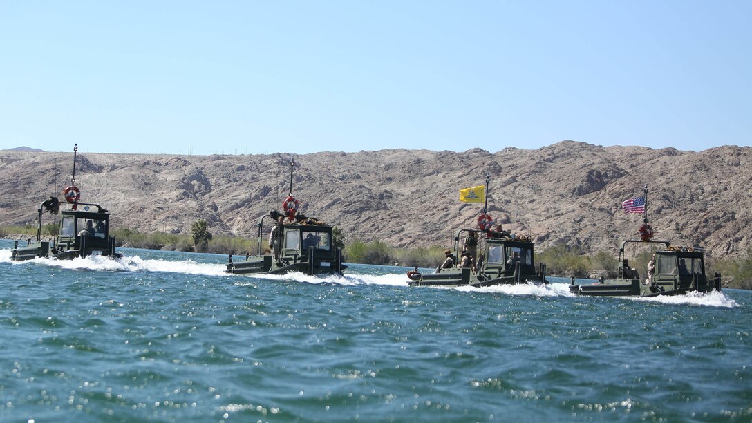Marines with Bridge Company, 7th Engineer Support Battalion, 1st Marine Logistics Group, operate Bridge Erection Boats as part of a rafting exercise on the Colorado River in Laughlin, Nev., March 17-21, 2014. More than 60 Marines trained in moving heavy equipment, to include 7-tons and Humvees, across a flowing body of water utilizing BEBs and an Improved Ribbon Bridge. The IRB is a multi-piece floating bridge that can function as a raft. The BEBs were used to push the raft against the current. Despite being accustomed to training in a bay with little to no current, these Marines managed to transport two 7-tons up the river at the same time.