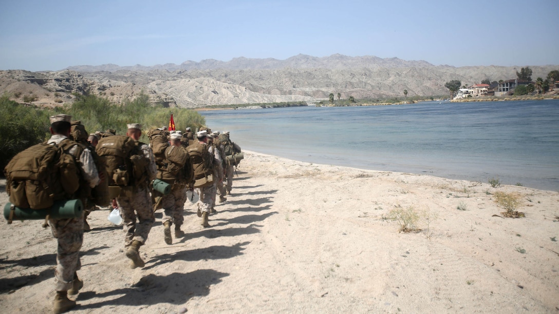 Marines with Bridge Company, 7th Engineer Support Battalion, 1st Marine Logistics Group, march to their training site for a rafting exercise on the Colorado River in Laughlin, Nev., March 17-21, 2014. More than 60 Marines trained in moving heavy equipment, to include 7-tons and Humvees, across a flowing body of water using Bridge Erection Boats and an Improved Ribbon Bridge. The IRB is a multi-piece floating bridge that can function as a raft. Despite being accustomed to training in a bay with little to no current, these Marines managed to transport two 7-tons up the river at the same time.