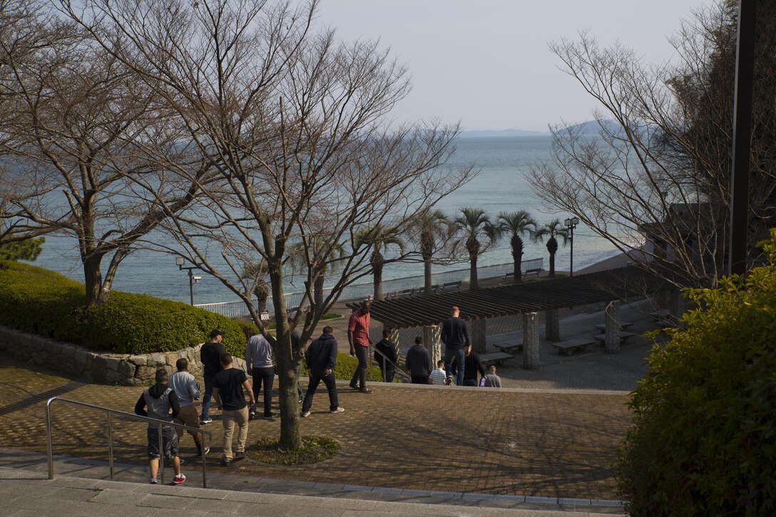 Service members with MALS-12 arrive to begin cleaning up Tsuzu Beach during a community relations event conducted by the Marine Aircraft Group 12 Chaplain's Office aboadr Marine Corps Air Station Iwakuni,Japan, March 13, 2015. Community relations events serve as an important tool in strengthening the bond between the U.S. and Japan. Major entities aboard station that conduct regular community relations events include the Marine Memorial Chapel, MAG-12 Chaplain's Office and the Single Marine Program.
