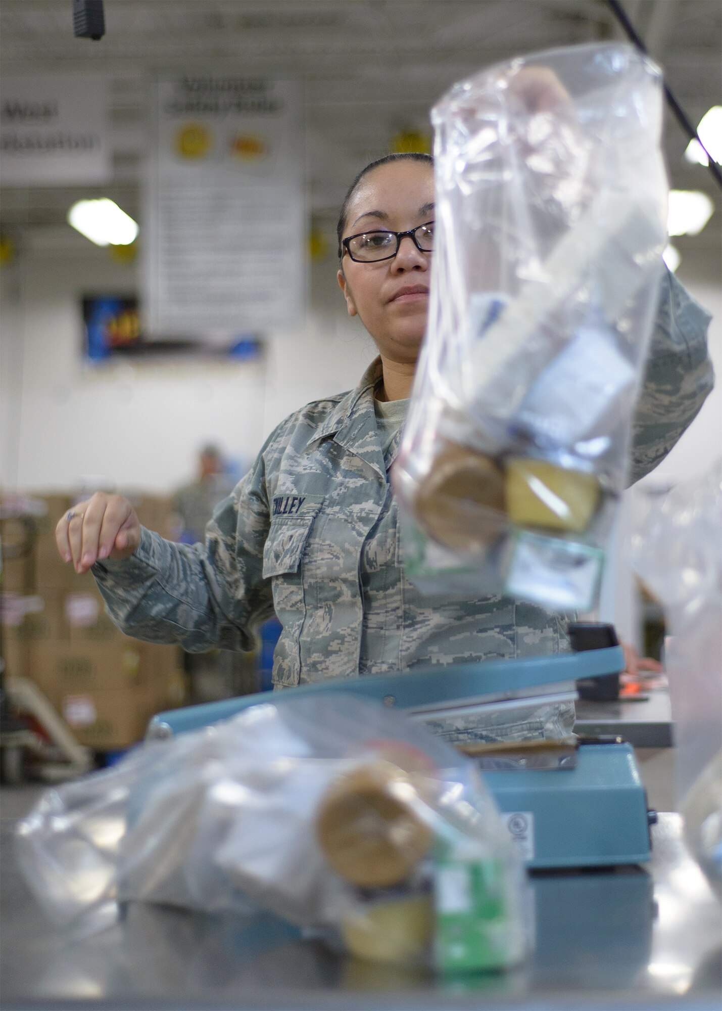 Senior Airman Susana Twilley, 71st Operations Support Squadron, Vance Air Force Base, Oklahoma, packs a lunch at the Regional Food Bank of Oklahoma in Oklahoma City March 9. Servicemembers from across the state teamed up with players from the Oklahoma City Thunder to package more than 20,000 pounds of food for Oklahoma families in 53 counties and 501 elementary schools. (U.S. Air Force photo \ David Poe)