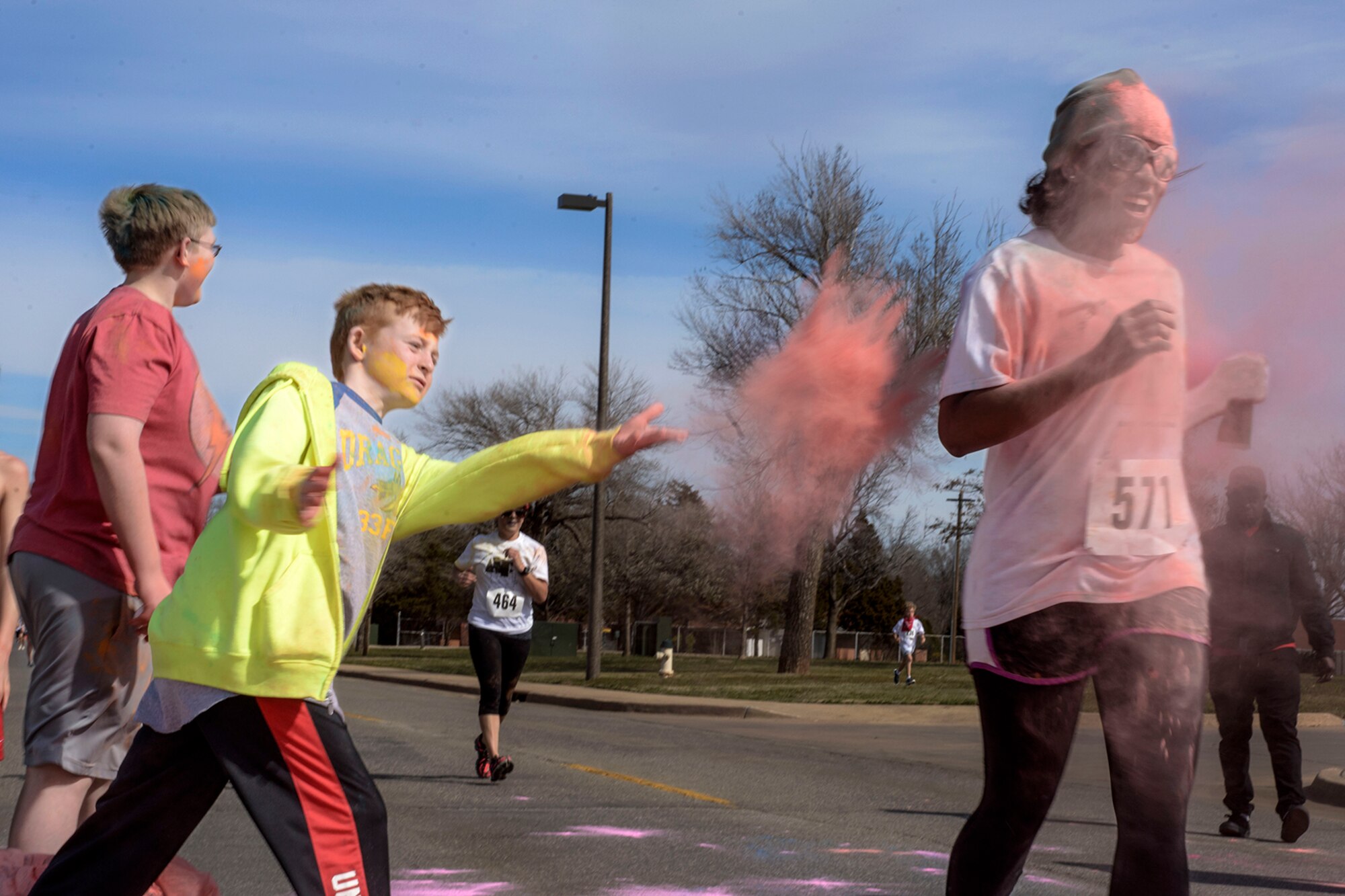 Todd Smoot, son of 33rd Flying Training Squadron's Lt. Col. Kevin Smoot, pitches in at the color run on base, March 14. Vance hosted the charitable run to support the Air Force Assistance Fund.  (U.S. Air Force photo / David Poe)


