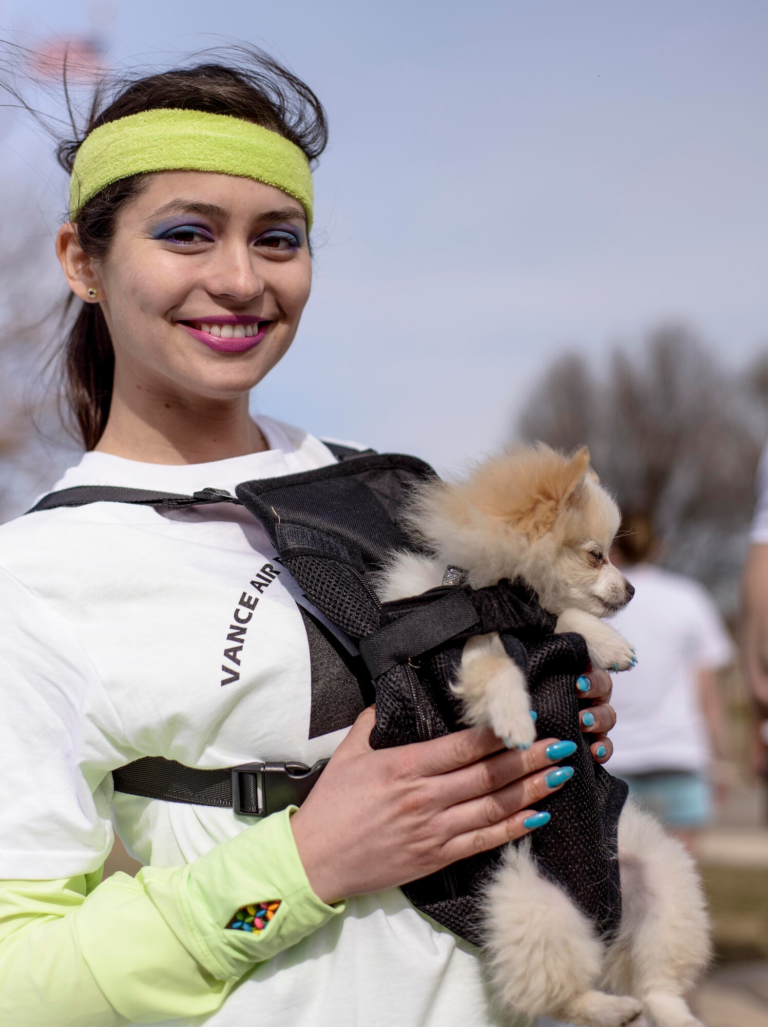 Senior Airman Jovanna Flor and her furry friend at the  base's first ever color run, March 14. More than 200 runners and volunteers colored Vance in support of the Air Force Assistance Fund. (U.S. Air Force photo / David Poe)

