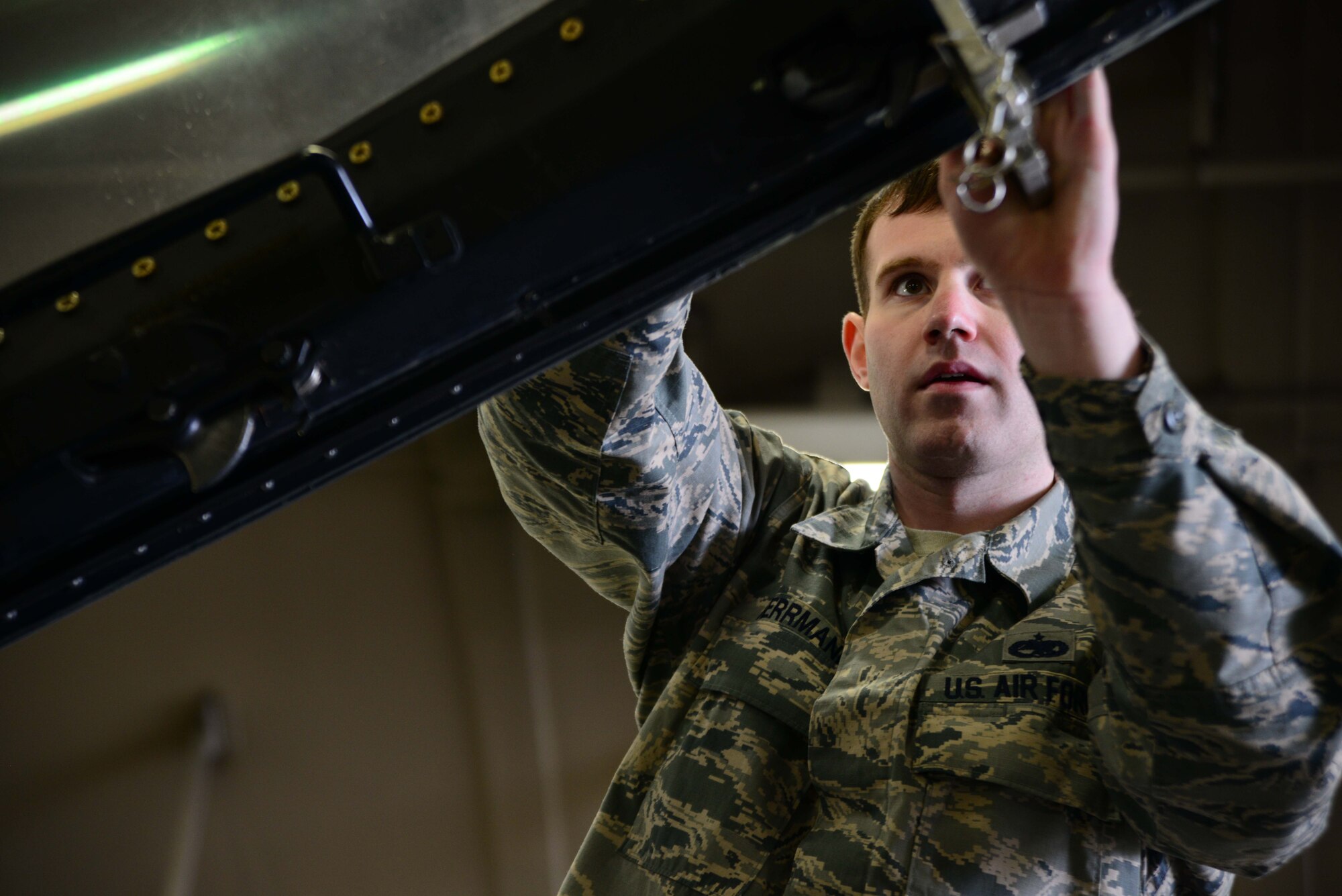 Staff Sgt. John Herrmann, 35th Maintenance Squadron egress systems craftsman, secures the canopy of an F-16 Fighting Falcon on Feb. 20, 2015, at Misawa Air Base, Japan. Herrmann was the team lead for a scheduled inspection for the jet’s canopy, which was removed by the base’s egress crew. (U.S. Air Force photo by Staff Sgt. Derek VanHorn)