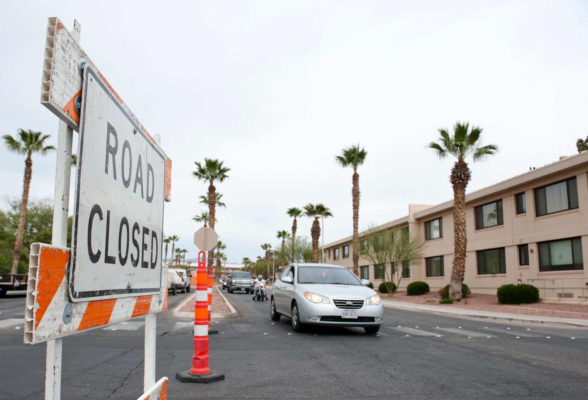 Cars wait a stop sign on Washington Avenue while navigating a road detour on Nellis Air Force Base, Nev., March 18, 2015. The detours were put in place on March 16, 2015 to make way for road construction. The project will take four months to complete and will occur in two phases. Traffic will remain open on Washington Avenue for the duration of the project and both directions will share one side of the road. During the first phase, construction will be done on areas of Washington Avenue in front of the U.S. Air Force Warfare Center as well as a section of Ellsworth Avenue. During Phase two, work will be done on the other side of Washington Avenue in front of the USAFWC, as well as Devlin Drive and Swaab Boulevard. For more information on the projects, contact Master Sgt. Julie Hanania, 99th Civil Engineer Squadron customer service section chief at 702-652-2301.