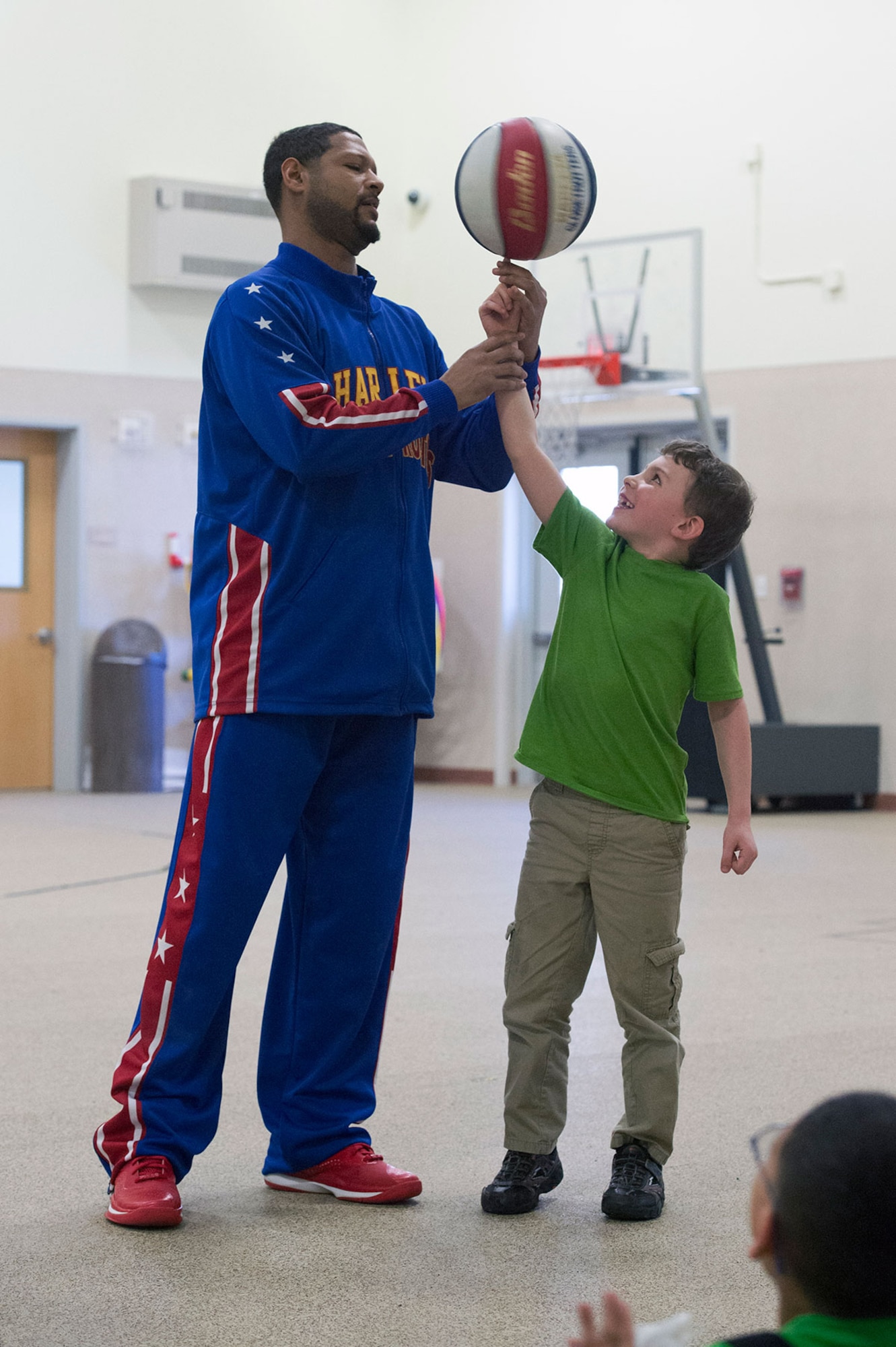 Harlem Globetrotter Handles Franklin visits Illa School Age Program children on Joint Base Elmendorf-Richardson to discuss bullying prevention, March 17, 2015. Known worldwide as the "Ambassadors of Goodwill"™, the iconic Harlem Globetrotters presented the community outreach program, "The ABCs of Bullying Prevention," in an effort to impact schools and communities around the world as well as and provide tools that kids can use on a daily basis to reduce bullying. (U.S. Air Force photo/Alejandro Pena)