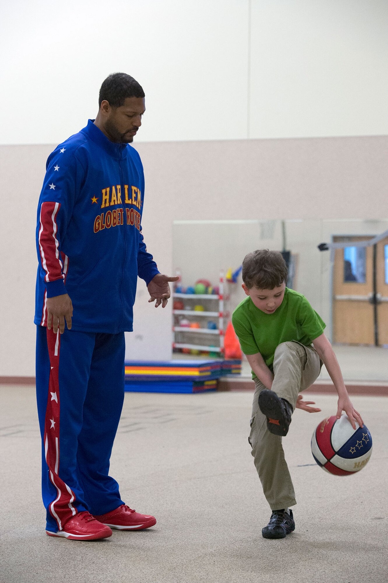 Harlem Globetrotter Handles Franklin visits Illa School Age Program children on Joint Base Elmendorf-Richardson to discuss bullying prevention, March 17, 2015. Known worldwide as the "Ambassadors of Goodwill"™, the iconic Harlem Globetrotters presented the community outreach program, "The ABCs of Bullying Prevention," in an effort to impact schools and communities around the world as well as and provide tools that kids can use on a daily basis to reduce bullying. (U.S. Air Force photo/Alejandro Pena)