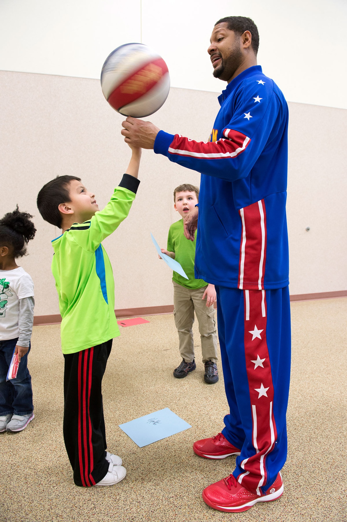 Harlem Globetrotter Handles Franklin visits Illa School Age Program children on Joint Base Elmendorf-Richardson to discuss bullying prevention, March 17, 2015. Known worldwide as the "Ambassadors of Goodwill"™, the iconic Harlem Globetrotters presented the community outreach program, "The ABCs of Bullying Prevention," in an effort to impact schools and communities around the world as well as and provide tools that kids can use on a daily basis to reduce bullying. (U.S. Air Force photo/Alejandro Pena)