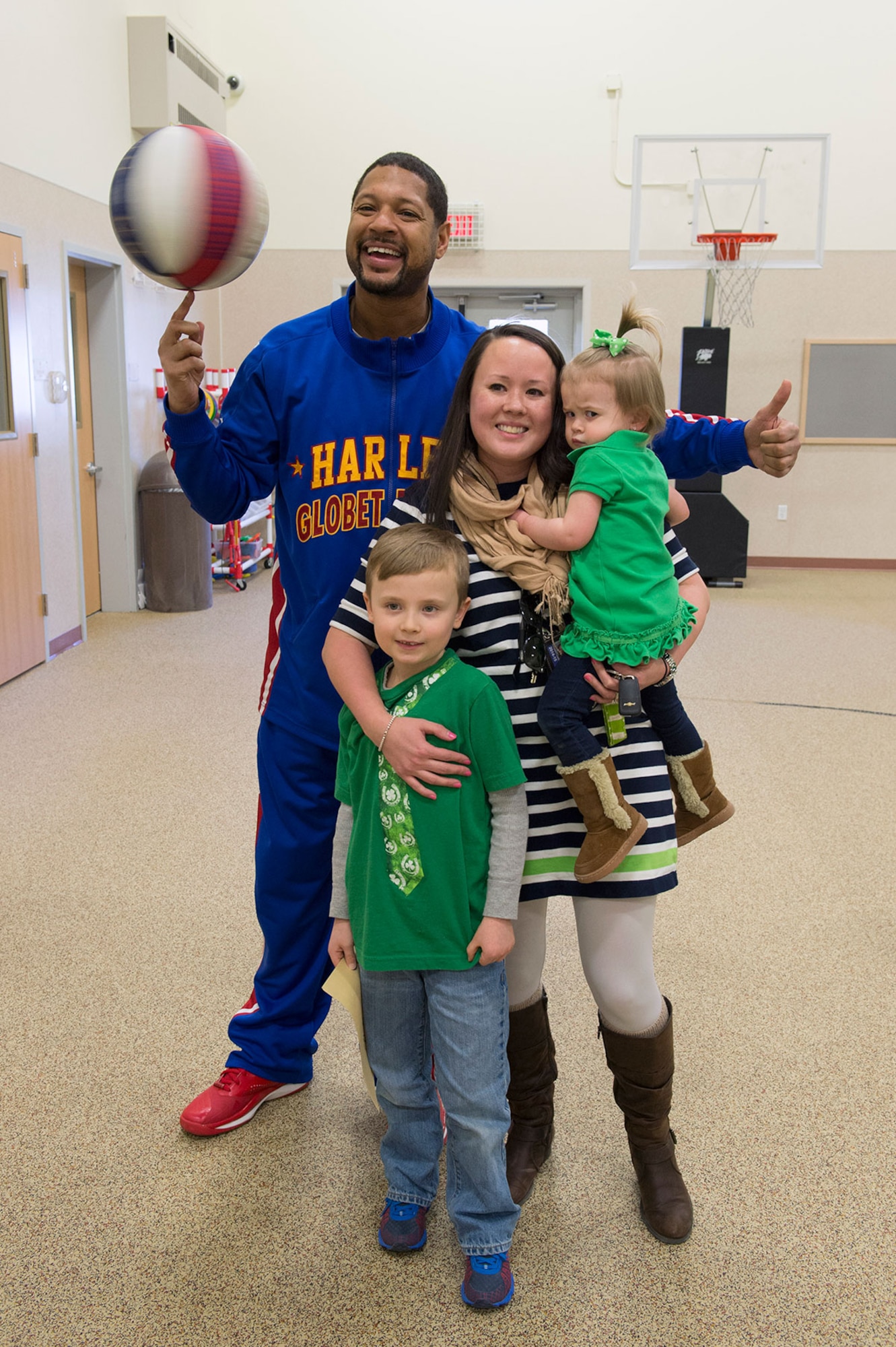 Harlem Globetrotter Handles Franklin poses for a fan picture while visiting Illa School Age Program children on Joint Base Elmendorf-Richardson to discuss bullying prevention, March 17, 2015. Known worldwide as the "Ambassadors of Goodwill"™, the iconic Harlem Globetrotters presented the community outreach program, "The ABCs of Bullying Prevention," in an effort to impact schools and communities around the world as well as and provide tools that kids can use on a daily basis to reduce bullying. (U.S. Air Force photo/Alejandro Pena)