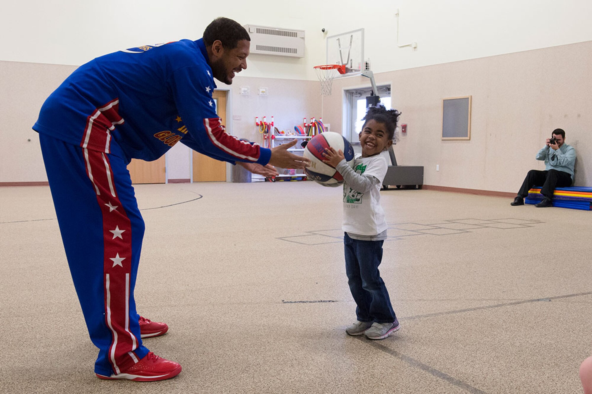 Harlem Globetrotter Handles Franklin interacts with Delainie Simon, 4, while visiting Illa School Age Program children on Joint Base Elmendorf-Richardson to discuss bullying prevention, March 17, 2015. Known worldwide as the "Ambassadors of Goodwill"™, the iconic Harlem Globetrotters presented the community outreach program, "The ABCs of Bullying Prevention," in an effort to impact schools and communities around the world as well as and provide tools that kids can use on a daily basis to reduce bullying. (U.S. Air Force photo/Alejandro Pena)