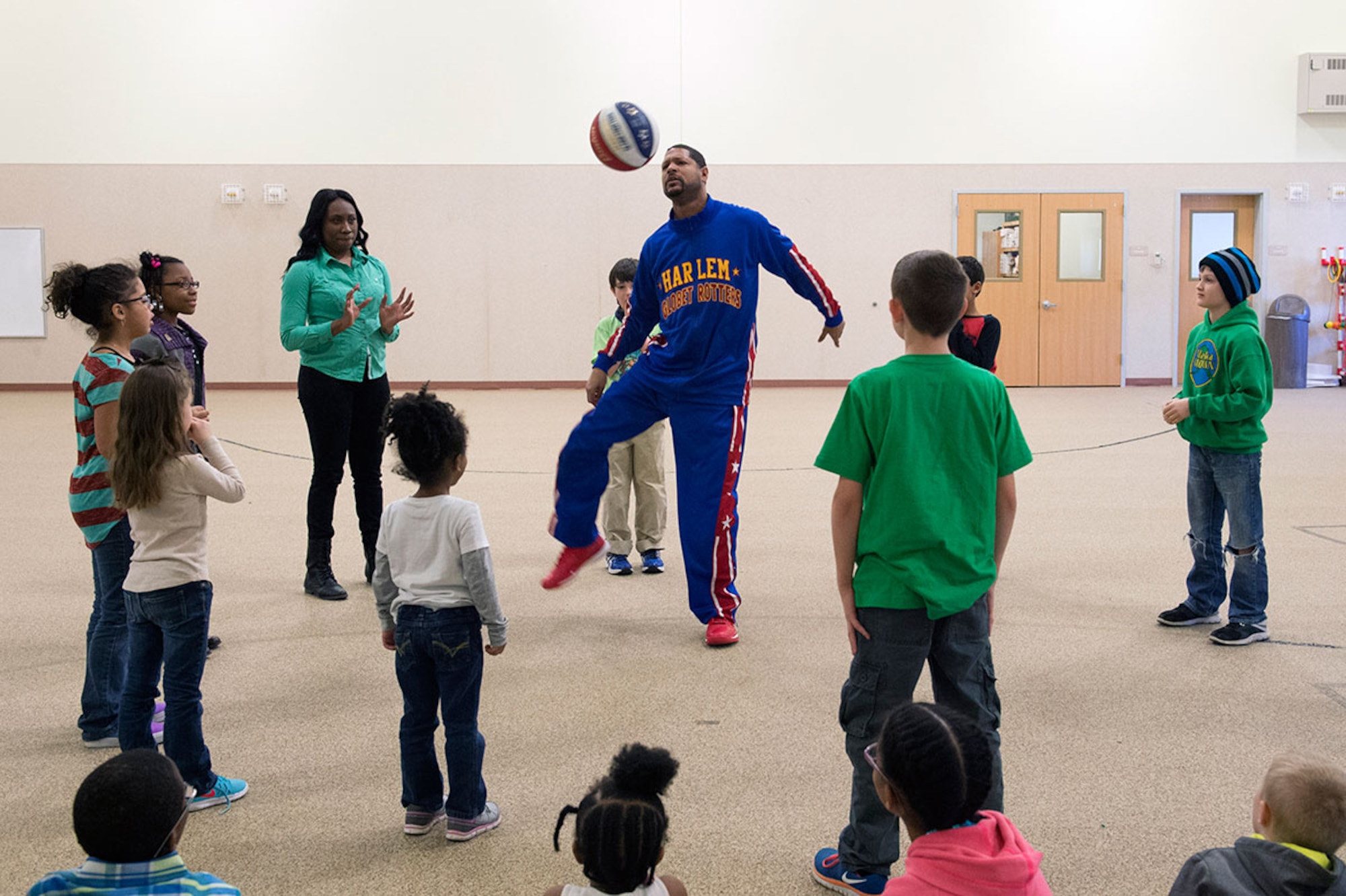 Harlem Globetrotter Handles Franklin visits Illa School Age Program children on Joint Base Elmendorf-Richardson to discuss bullying prevention, March 17, 2015. Known worldwide as the "Ambassadors of Goodwill"™, the iconic Harlem Globetrotters presented the community outreach program, "The ABCs of Bullying Prevention," in an effort to impact schools and communities around the world as well as and provide tools that kids can use on a daily basis to reduce bullying. (U.S. Air Force photo/Alejandro Pena)
