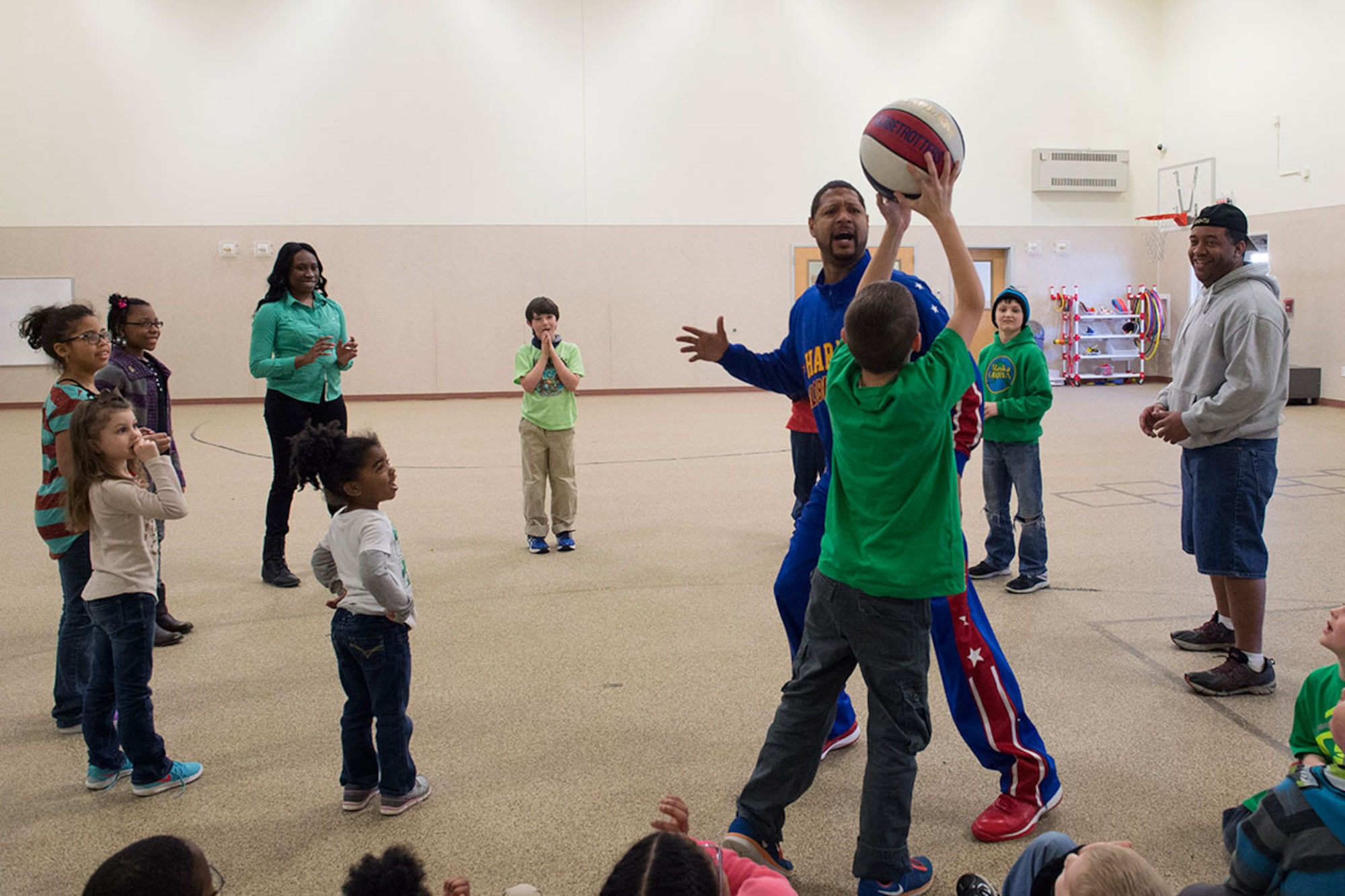 Harlem Globetrotter Handles Franklin visits Illa School Age Program children on Joint Base Elmendorf-Richardson to discuss bullying prevention, March 17, 2015. Known worldwide as the "Ambassadors of Goodwill"™, the iconic Harlem Globetrotters presented the community outreach program, "The ABCs of Bullying Prevention," in an effort to impact schools and communities around the world as well as and provide tools that kids can use on a daily basis to reduce bullying. (U.S. Air Force photo/Alejandro Pena)