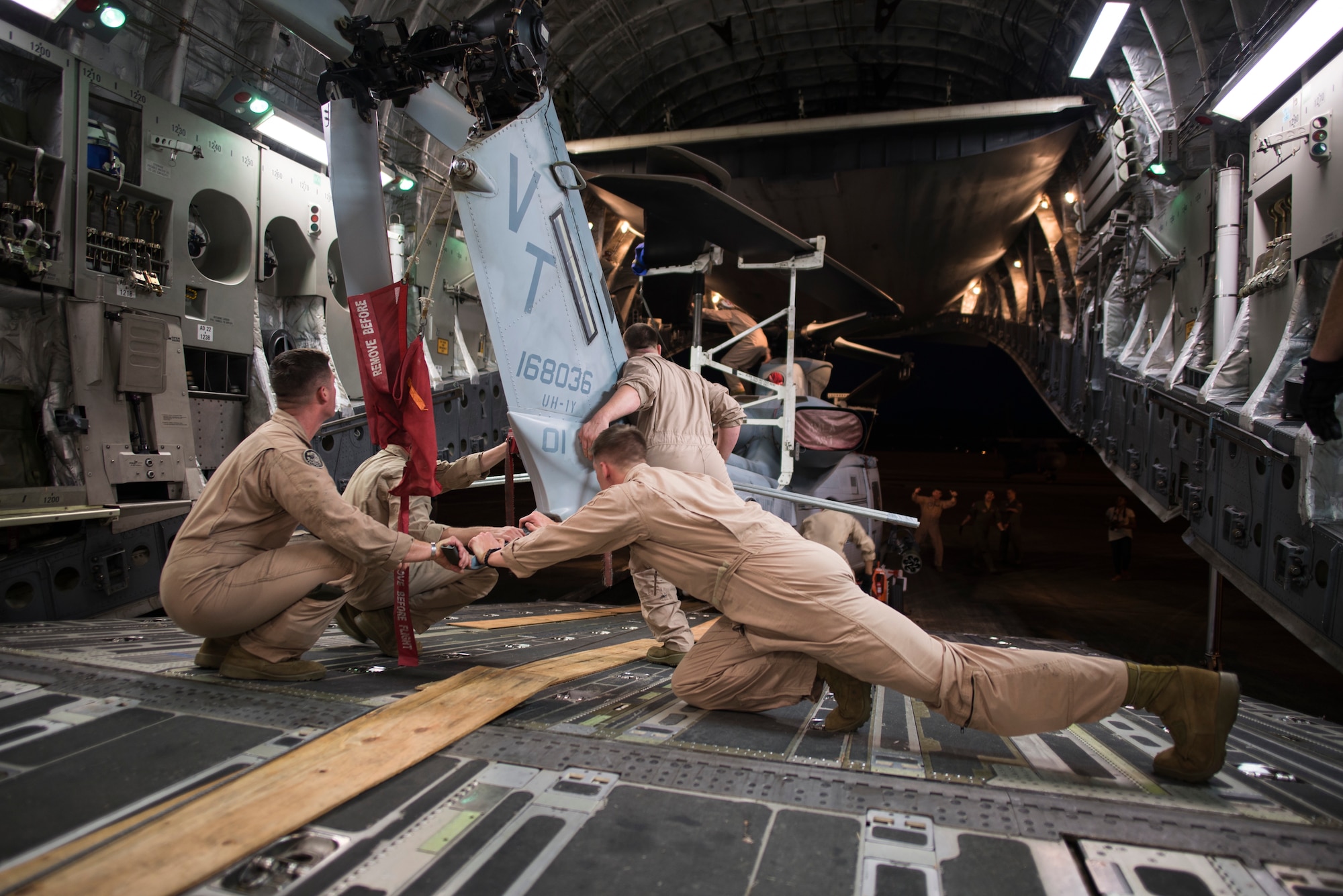 Marines assigned to Marine Corps Base Hawaii offload a UH-1Y Huey from the back of a C-17 Globemaster III in preparation of the Langkawi International Maritime and Aerospace Exhibition, Malaysia, March 16, 2015. Defense Department participation in the LIMA 15 airshow strengthens military-to-military relationships and underscores the cooperation agreements between the U.S. and Malaysia. (U.S. Air Force photo by 1st Lt. Elias Zani/Released)