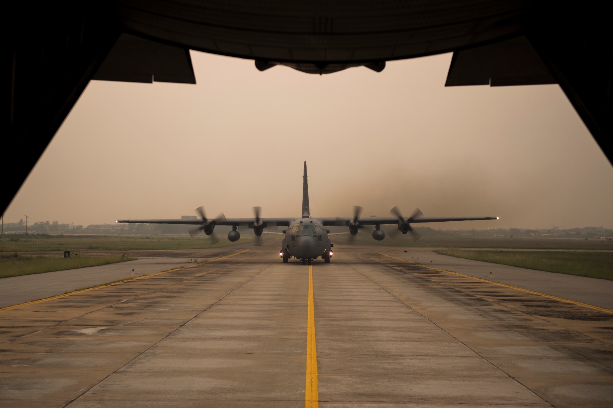 Two U.S. Air Force C-130's taxi after a formation flight during exercise Cope Tiger Udonthani, Thailand, March 17, 2015. CT15 includes 22 total flying units and over 1390 personnel from three countries and continues the growth of strong, interoperable, and beneficial relationships within the Asia-Pacific region through integration of airborne and land-based command and control assets.(U.S. Air Force photo by Airman 1st Class Taylor Queen/Released)