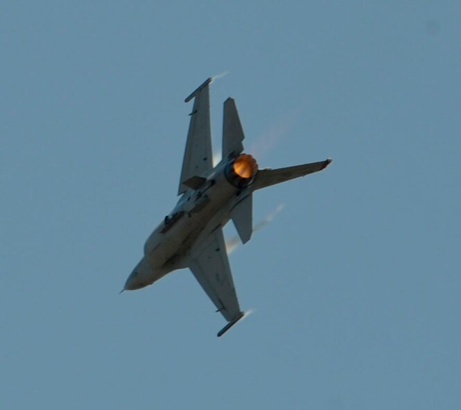 An F-16 Fighting Falcon, flown by Capt. Austin Brown, a Pacific Air Forces' F-16 Demonstration Team, flies through the air above the flightline at Langkawi International Airport, Malaysia, March 17, 2015. The U.S. demonstration team joined more than 60 countries for the Langkawi International Maritime and Aerospace Exhibition 15. U.S. participation in LIMA 15 increases understanding between U.S. and Malaysian Airmen while also improving interoperability and building stronger relationships allowing both nations to work better together to provide greater regional stability. (U.S. Air Force photo by Tech. Sgt. Terri Paden/RELEASED)