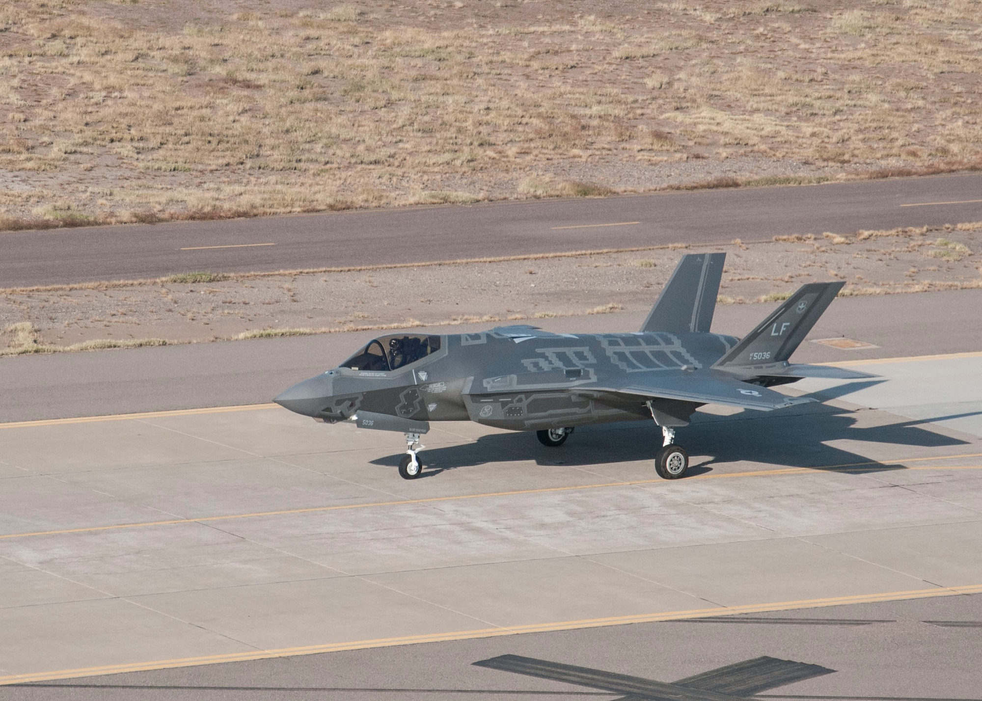 An F-35 fighter jet stands on a runway at Luke Air Force Base, Arizona, in December 2014. Luke will eventually be home to 144 F-35s, making it the largest F-35 air base in the world. (U.S. Air Force Photo/Released/Monica Guevara)