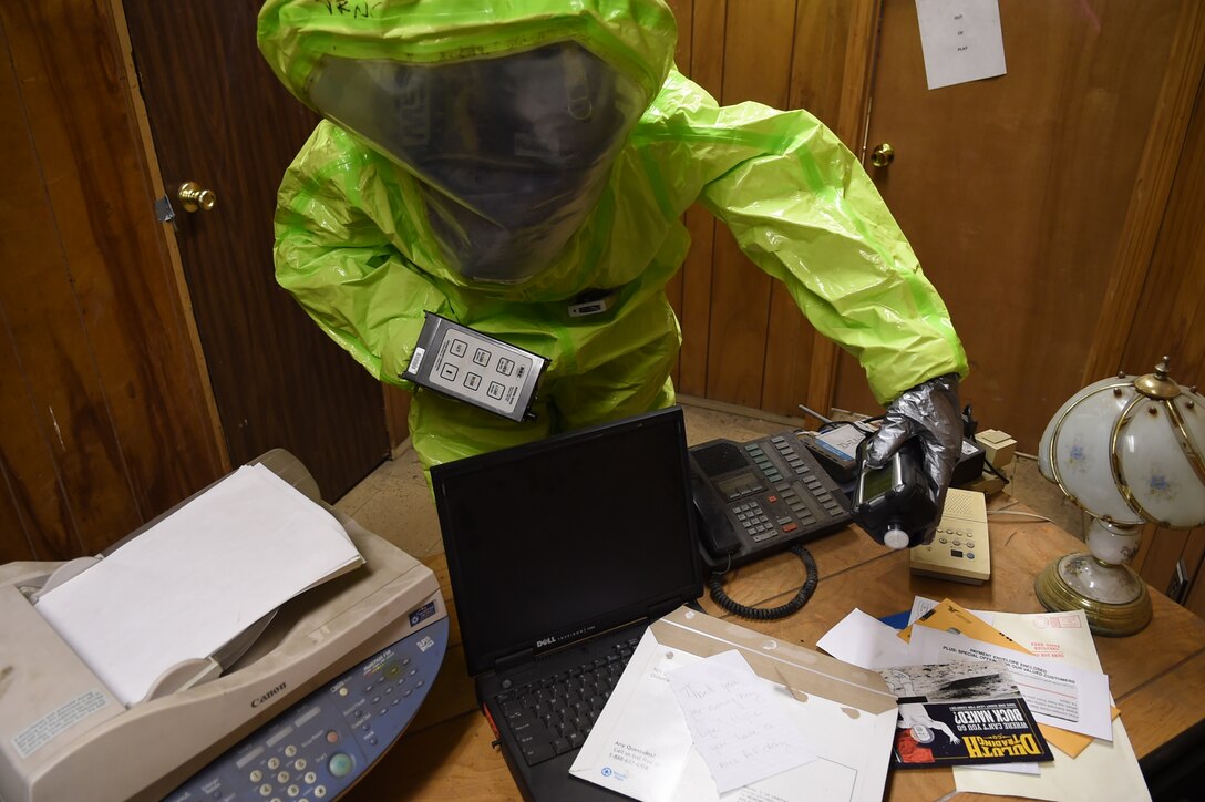 Senior Airman Tony Pauline, 779th Aerospace Medical Squadron bioenvironmental engineering technician, scans an office desk for a potential chemical agent during a training exercise in the Memorial Tunnel at the Center for National Response in Gallagher, WV., March 17, 2015. This training is part of the annual Black Flag exercise for first responders. Pauline is stationed at Joint Base Andrews, Md. (U.S. Air Force photo/Airman 1st Class Joshua R. M. Dewberry)