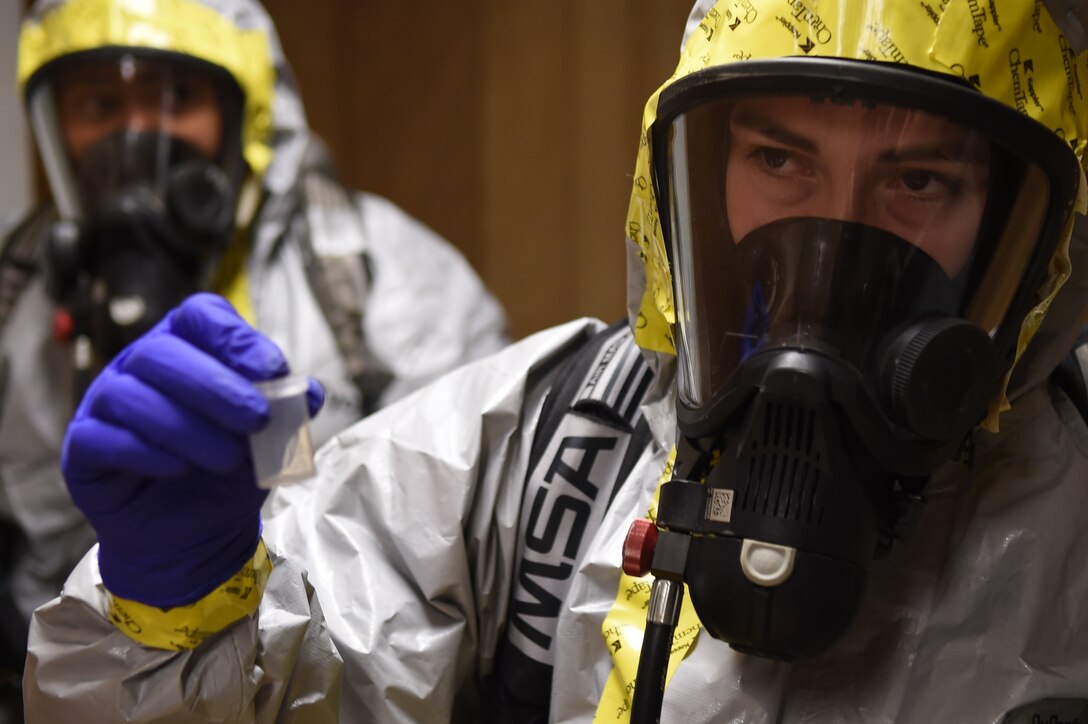 Airman Marlene Zeledon (right), samples a chemical agent during a training exercise with Staff Sgt. Yaoska Quintana (left), in the Memorial Tunnel at the Center for National Response in Gallagher, WV., March 17, 2015. This training is part of the annual Black Flag exercise for first responders. Zeledon is an 11th Civil Engineer Squadron emergency management journeyman and Quintana is the 779th Aerospace Medical Squadron NCO in-charge of flight readiness, Joint Base Andrews, Md. (U.S. Air Force photo/Airman 1st Class Joshua R. M. Dewberry)