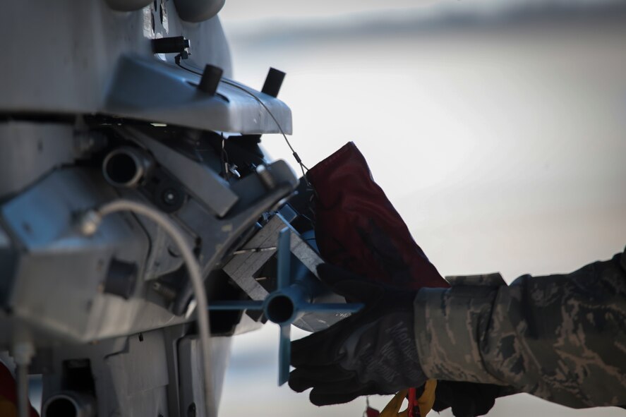 U.S. Air Force Airman 1st Class Rachel Rivera loads practice munitions onto an F-16 Fighting Falcon at Atlantic City Air National Guard Base, N.J., March 7, 2015. Rivera is a weapons systems specialist with the New Jersey Air National Guard's 177th Fighter Wing. (U.S. Air National Guard photo by Tech. Sgt. Matt Hecht/Released)