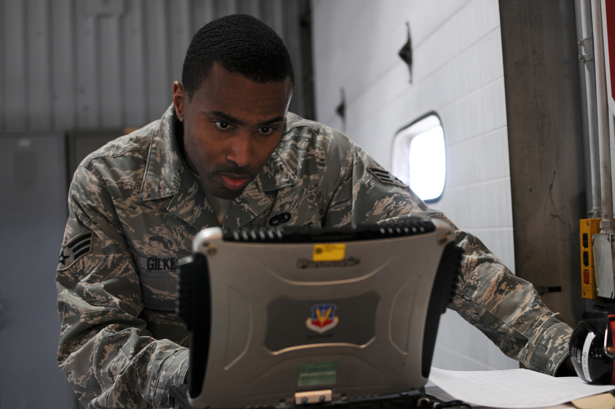 A picture of U.S. Air Force Senior Airman Gregory Gilkes, from the New Jersey Air National Guard's 177th Fighter Wing in Egg Harbor Township, N.J., preparing to inspect a light cart.