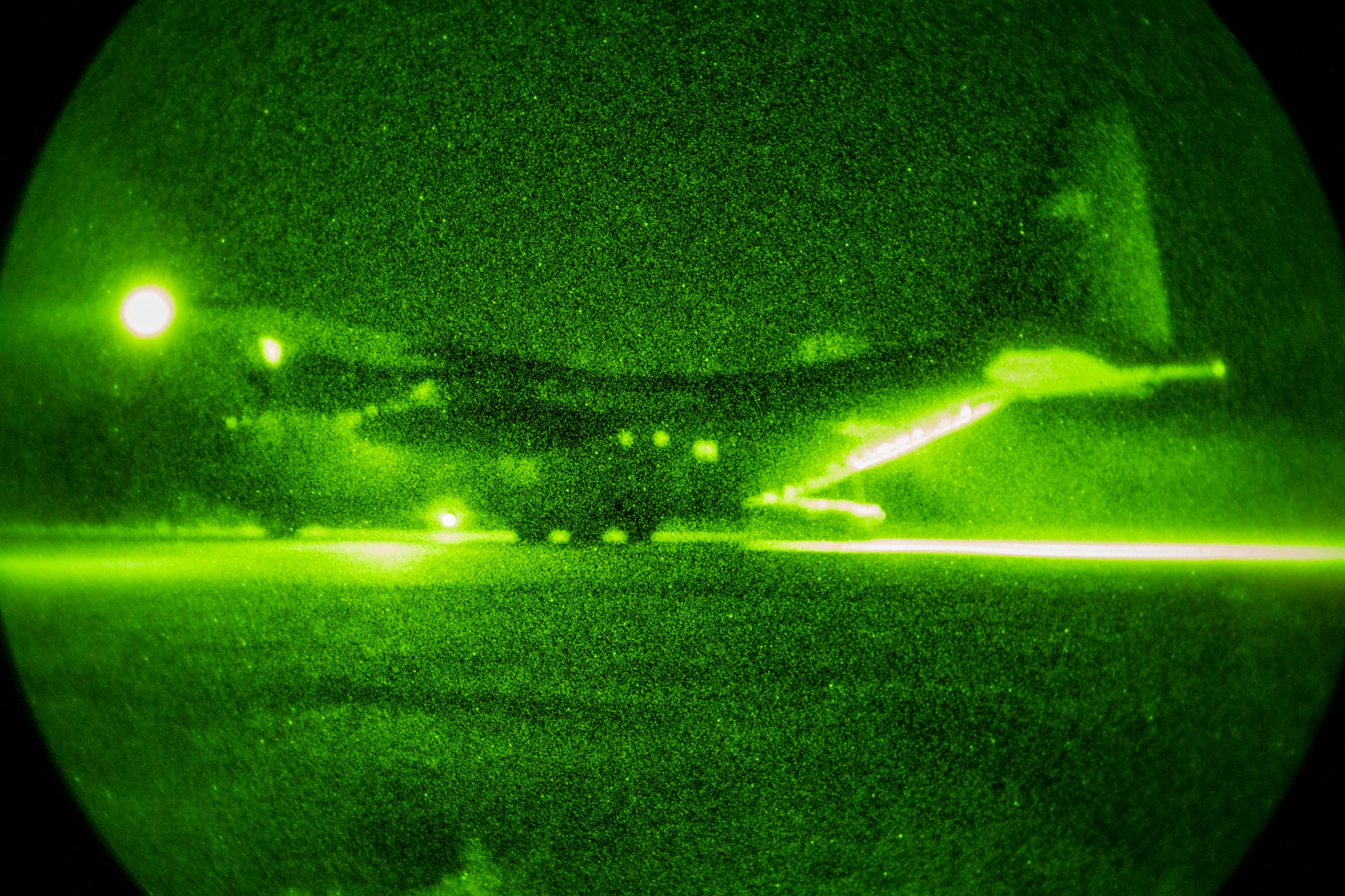 Two U.S. Air Force C-130's conduct a night Containment Delivery System airdrop during Exercise Cope Tiger 15 near Udon, Thailand, March 11, 2015. CT15 includes 22 total flying units and over 1390 personnel from three countries and continues the growth of strong, interoperable, and beneficial relationships within the Asia-Pacific region through integration of airborne and land-based command and control assets.(U.S. Air Force photo by Airman 1st Class Taylor Queen/Released)