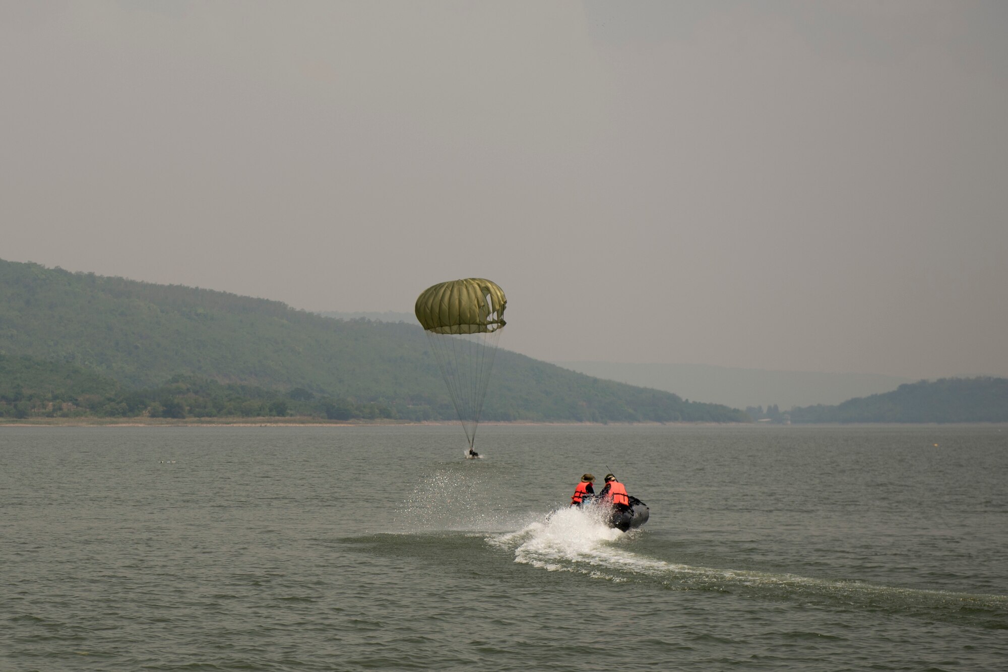 U.S. Air Force, Thai and Singaporean military conduct static and High Altitude Low Opening jumps from a U.S. C-130 during Exercise Cope Tiger 15 near Korat, Thailand, March 10, 2015. CT15 includes 22 total flying units and over 1390 personnel from three countries and continues the growth of strong, interoperable, and beneficial relationships within the Asia-Pacific region through integration of airborne and land-based command and control assets.(U.S. Air Force photo by Airman 1st Class Taylor Queen/Not Reviewed)