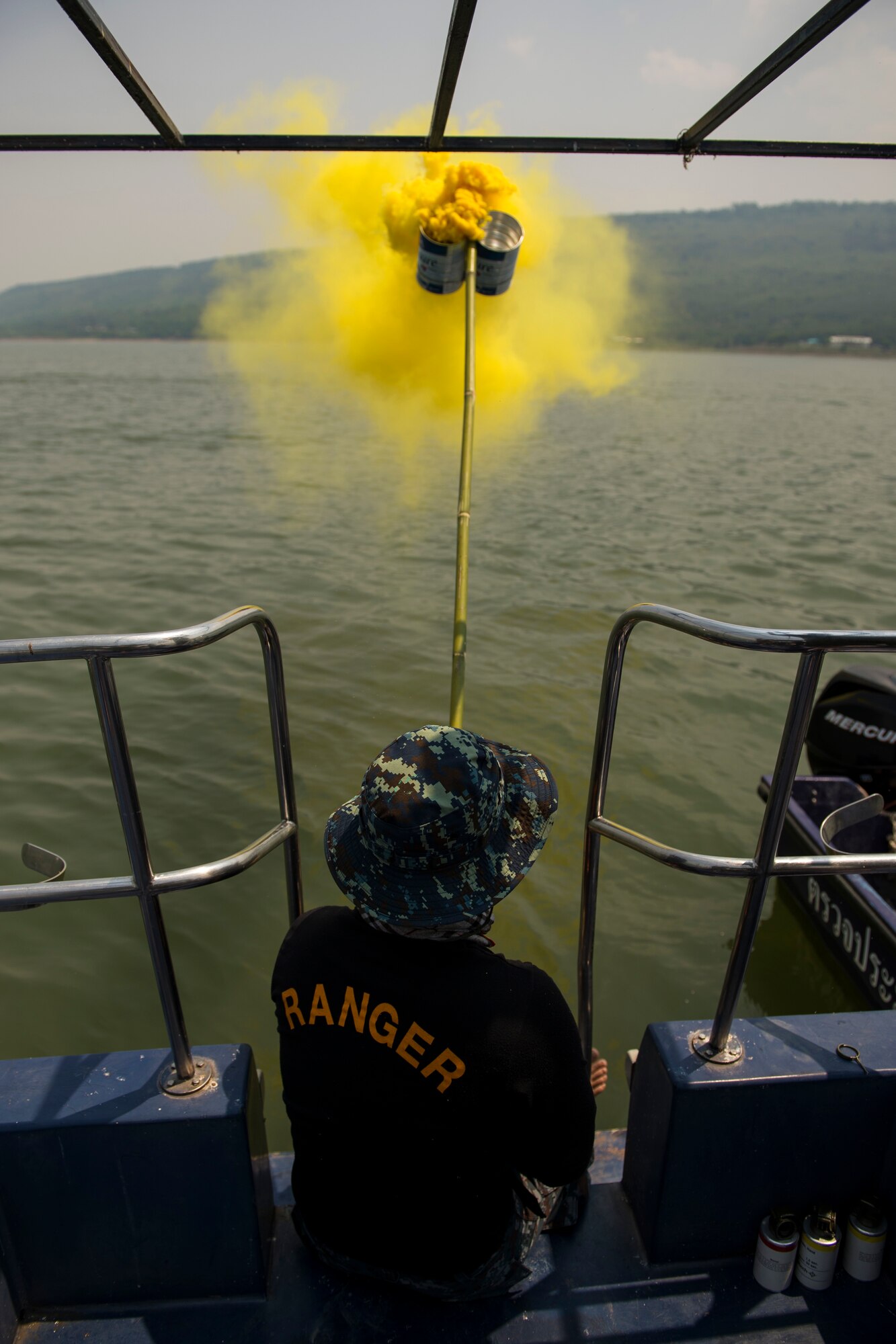 A Royal Thai Air Force Combat Controller marks a drop zone with smoke during Exercise Cope Tiger 15 near Korat, Thailand, March 10, 2015. CT15 includes 22 total flying units and over 1390 personnel from three countries and continues the growth of strong, interoperable, and beneficial relationships within the Asia-Pacific region through integration of airborne and land-based command and control assets.(U.S. Air Force photo by Airman 1st Class Taylor Queen/Not Reviewed)