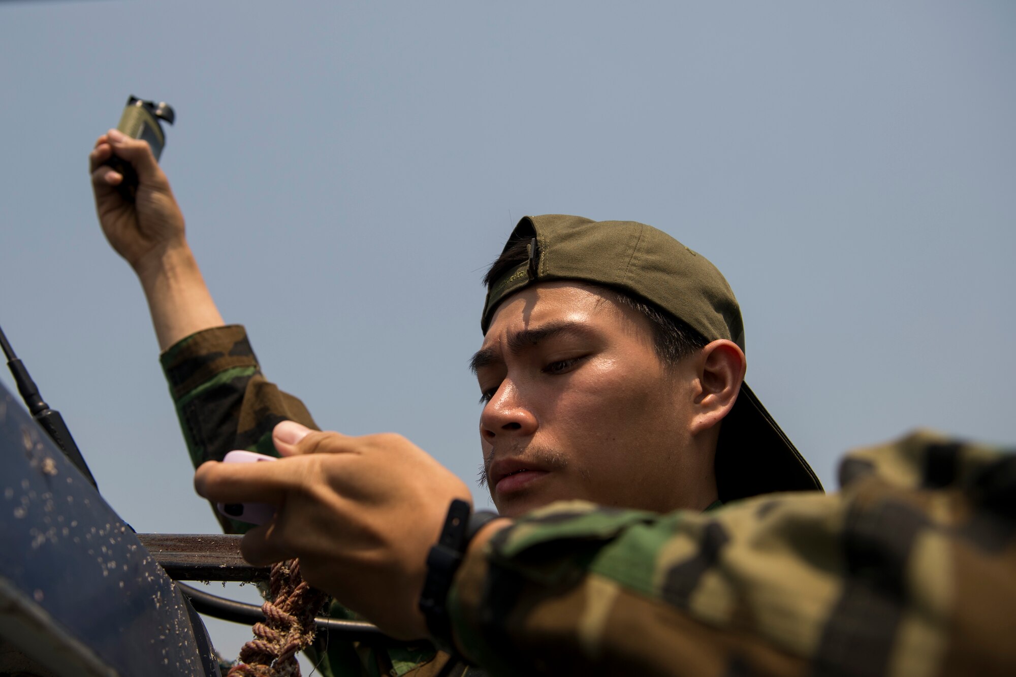 A Royal Thai Air Force Combat Controller checks wind speed at a drop zone during Exercise Cope Tiger 15 near Korat, Thailand, March 10, 2015. CT15 includes 22 total flying units and over 1390 personnel from three countries and continues the growth of strong, interoperable, and beneficial relationships within the Asia-Pacific region through integration of airborne and land-based command and control assets.(U.S. Air Force photo by Airman 1st Class Taylor Queen/Not Reviewed)