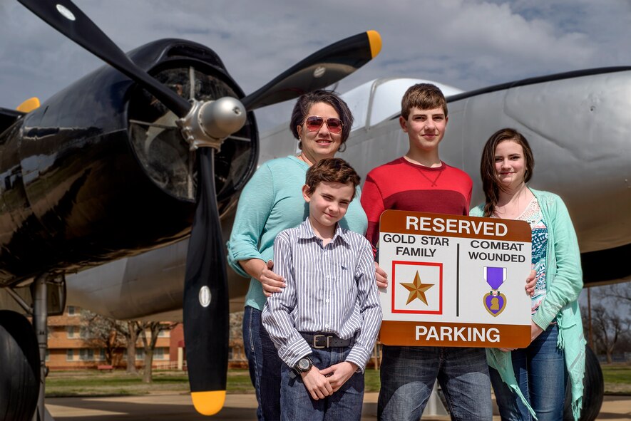 VANCE AIR FORCE BASE, Okla. -- Miriam Hamilton and children (from left) Andru Nylander, Tyler Nylander and Elisabeth Nylander at Vance Air Force Base, Okla., March 17. On request from Hamilton, the widow of Silver Star recipient Capt. Nathan Nylander, Vance will soon install reserved parking signs to recognize Gold Star Families and Purple Heart recipients. (U.S. Air Force photo / David Poe) 