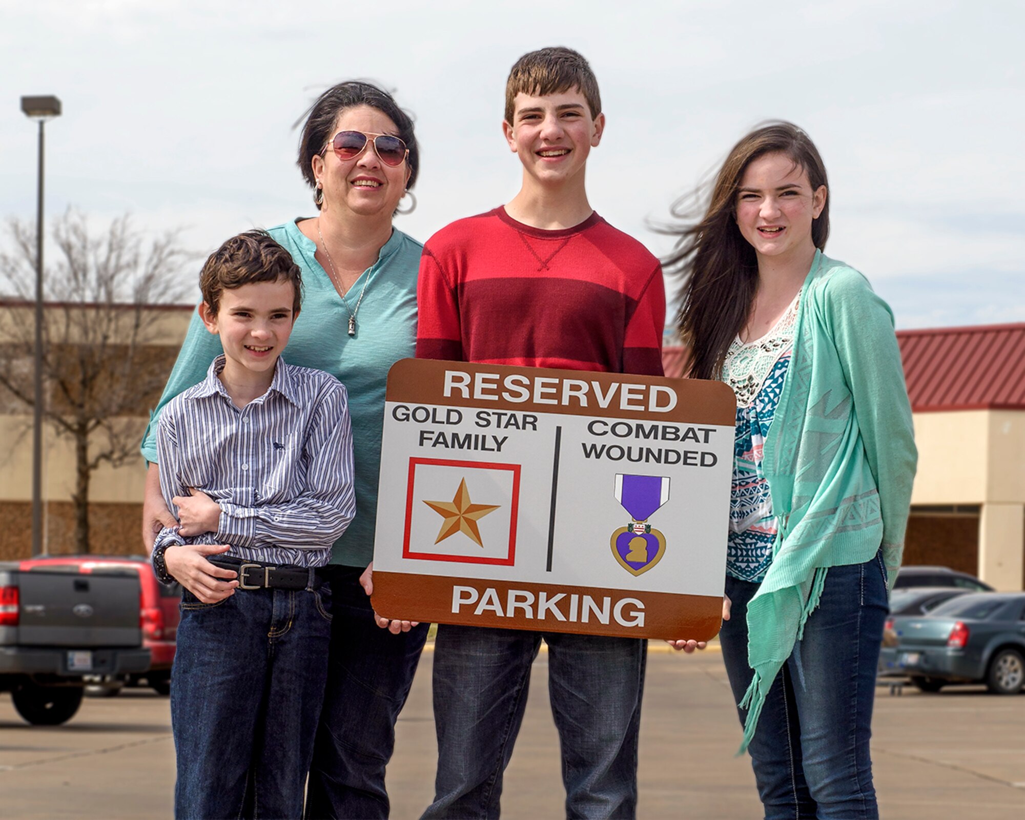 VANCE AIR FORCE BASE, Okla. -- Miriam Hamilton and children (from left) Andru Nylander, Tyler Nylander and Elisabeth Nylander at Vance Air Force Base, Okla., March 17. On request from Hamilton, the widow of Silver Star recipient Capt. Nathan Nylander, Vance will soon install reserved parking signs to recognize Gold Star Families and Purple Heart recipients. (U.S. Air Force photo / David Poe)