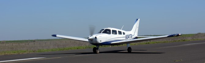 A Piper Archer III aircraft piloted by Staff Sgt. Brian Abbott, 660th Aircraft Maintenance Squadron KC-10 crew chief, speeds down the runway at the Travis Aero Club in Rio Vista, Calif., March 5. Abbott, a certified pilot, was conducting an instrumentation training flight. (U.S. Air Force Photo/Tech. Sgt. James M. Hodgman)