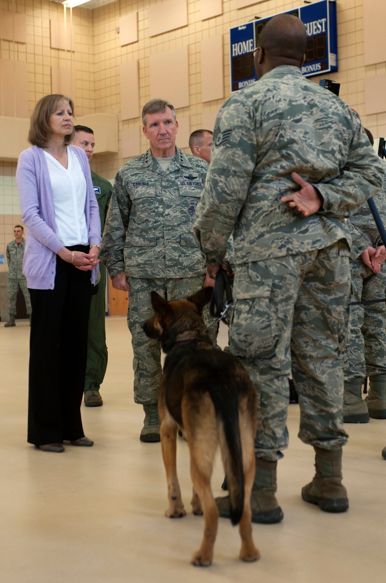 U.S. Air Force Gen. Hawk Carlisle, commander of Air Combat Command, and his wife, Mrs. Gillian Carlisle, meet Staff Sgt. Dontarie Russ, 633rd Security Forces Squadron military working dog handler, and his partner, Risa, during tour at Langley Air Force Base, Va., March 13, 2015. During his visit, Carlisle spoke to Airmen about their missions and contributions to JBLE to gain a first-hand look at the diverse missions carried out each day across both installations.  (U.S. Air Force photo by Senior Airman R. Alex Durbin/Released)