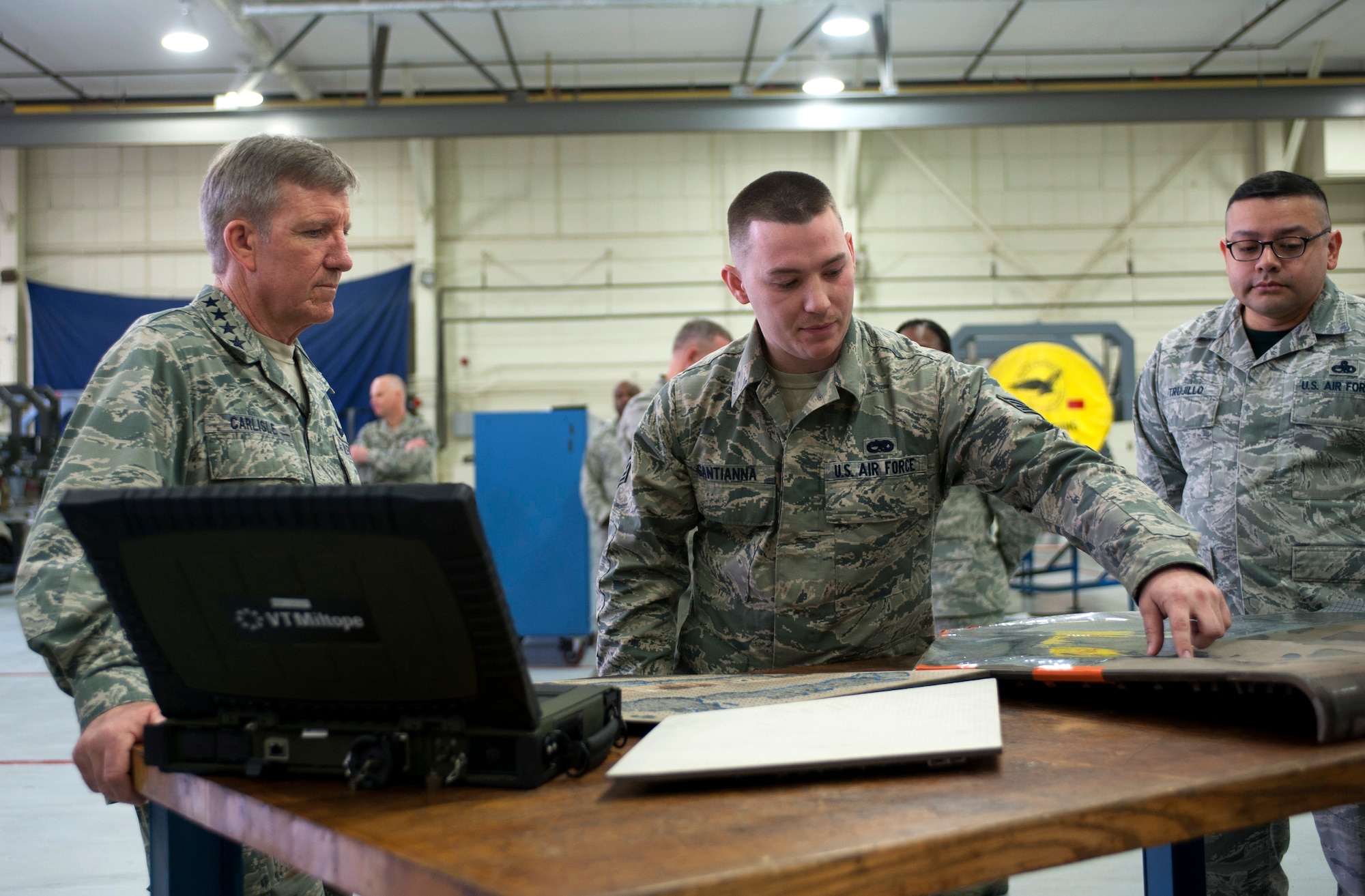 U.S. Air Force Gen. Hawk Carlisle, commander of Air Combat Command, listens to Staff Sgt. Mathew Santianna, 1st Maintenance Squadron jet engine intermediate maintenance journeyman, describe procedures for repairing components of the F-22 Raptor during an installation-wide tour at Langley Air Force Base, Va., March 13, 2015. During his time at the maintenance shops, Carlisle witnessed the fusion of active-duty and Virginia Air National Guard forces in support of the Total Force Integration initiative. (U.S. Air Force photo by Senior Airman R. Alex Durbin/Released)
