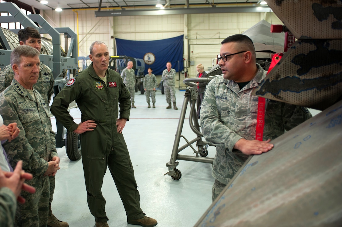 U.S. Air Force Gen. Hawk Carlisle, commander of Air Combat Command, receives a brief by Master Sgt. Juan Trujillo, 1st Maintenance Squadron jet engine intermediate maintenance shop non-commissioned officer in charge, about the shop’s operations and responsibilities within the 1st Fighter Wing during a tour at Langley Air Force Base, Va., March 13, 2015. Carlisle, Chief Master Sgt. Steve McDonald, command chief of Air Combat Command, and their wives, Gillian and Jennifer, visited the 633rd Air Base Wing, 1st FW, 192nd Fighter Wing and 733rd Mission Support Division. (U.S. Air Force photo by Senior Airman R. Alex Durbin/Released)