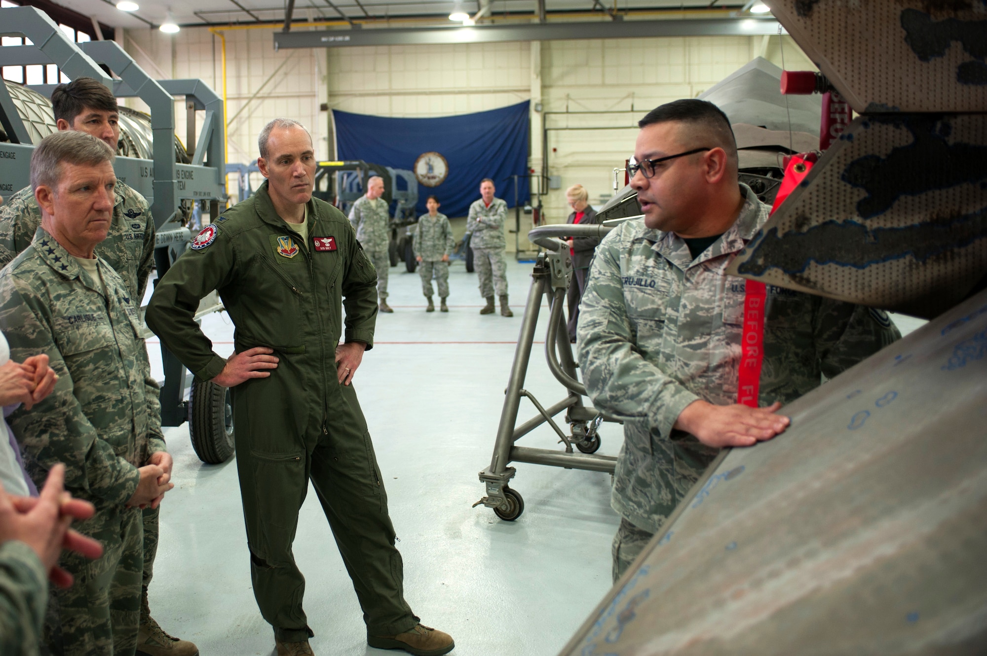 U.S. Air Force Gen. Hawk Carlisle, commander of Air Combat Command, receives a brief by Master Sgt. Juan Trujillo, 1st Maintenance Squadron jet engine intermediate maintenance shop non-commissioned officer in charge, about the shop’s operations and responsibilities within the 1st Fighter Wing during a tour at Langley Air Force Base, Va., March 13, 2015. Carlisle, Chief Master Sgt. Steve McDonald, command chief of Air Combat Command, and their wives, Gillian and Jennifer, visited the 633rd Air Base Wing, 1st FW, 192nd Fighter Wing and 733rd Mission Support Division. (U.S. Air Force photo by Senior Airman R. Alex Durbin/Released)