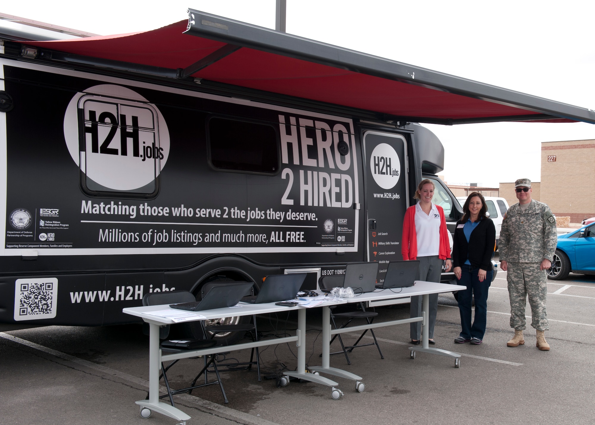 Jennifer Mastin, event scheduler for Hero to Hired, Cynthia Estrada, Southwest Employer Support of the Guard and Reserve coordinator, and Maj. Todd Kontny, New Mexcio ESGR liaison and employment coordinator visits the Exchange parking lot at Holloman Air Force Base, N.M. March 18. They promoted awareness of joint forces website ebenefits.va.org. The website was created to provide meaningful employment to active duty, National Guard, and Reserve service member, veterans, and their spouses for free. (U.S. Air Force photo by Staff Sgt. E’Lysia A. Wray/Released)