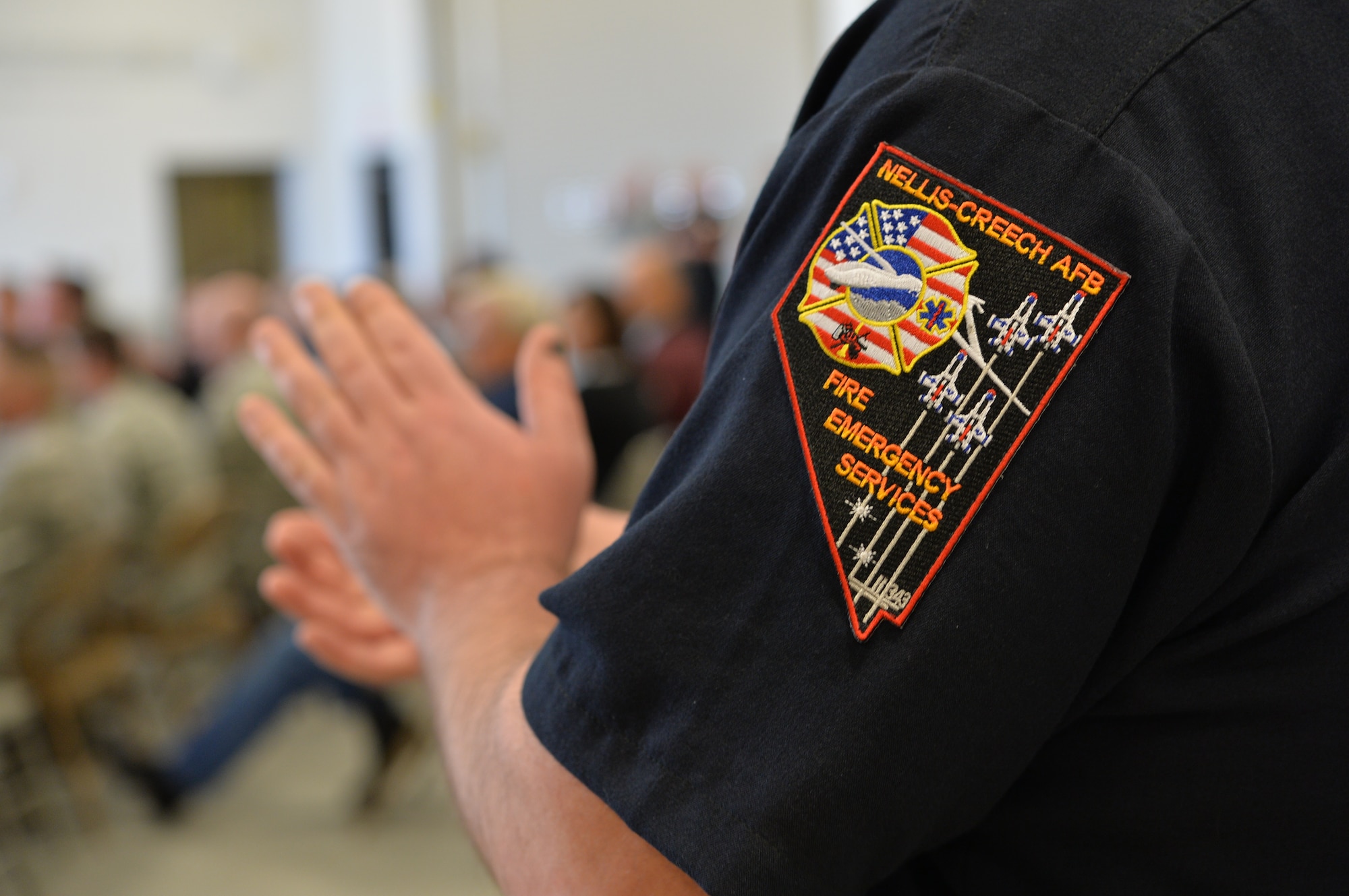 The Nellis-Creech Fire Emergency Services Flight’s Fire Station 6 personnel applaud the speaker during the  Fire Station 6 ribbon cutting ceremony March 4, 2015, at Creech Air Force Base, Nevada. The new facility will keep the unit’s mission in line with DoD emergency time and distance response mandates, where 'response time' is most often the critical factor in successful emergency mitigation.  (U.S. Air Force photo by Senior Airman Adarius Petty/Released)