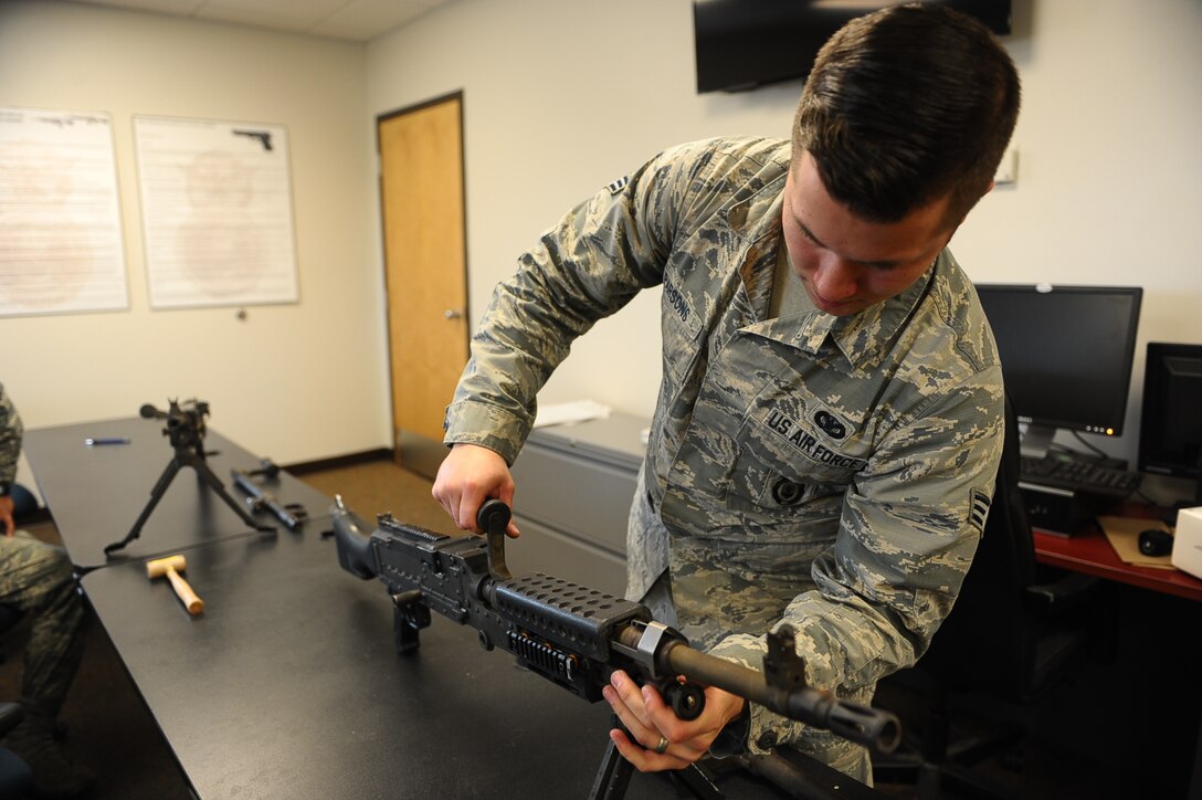 Senior Airman Anthony Parsons, 14th Security Forces Squadron Combat Arms Instructor, inspects a weapon Feb. 24 on Columbus Air Force Base, Miss. Columbus AFB defenders play a huge role in keeping both personnel and aircraft safe so the mission of producing pilots never has to stop. (U.S. Air Force photo/Airman Daniel Lile)