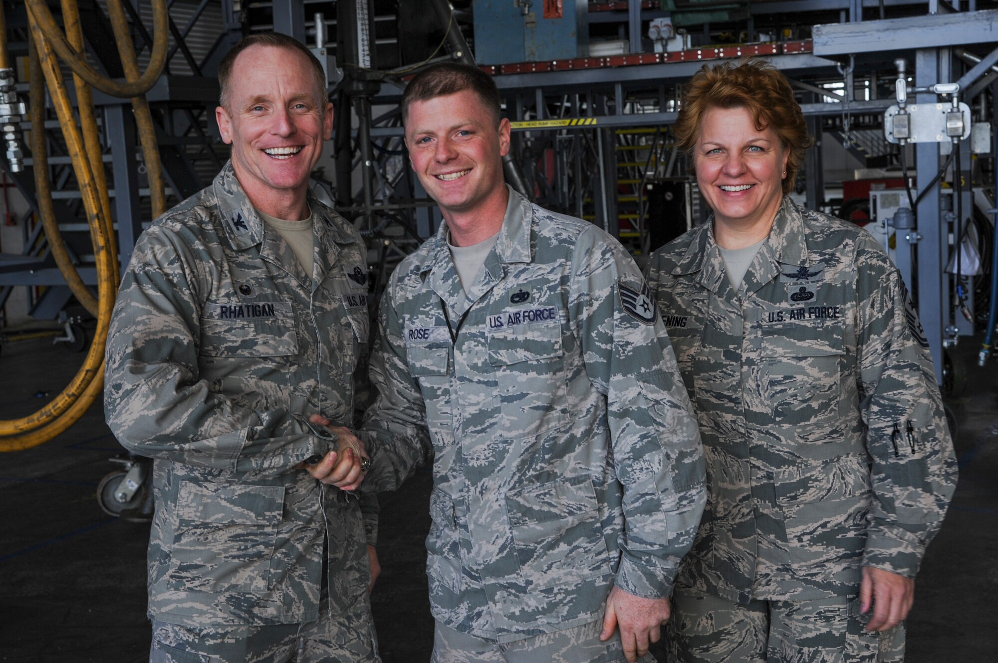 Col. Patrick Rhatigan, 19th Airlift Wing commander, and Chief Master Sgt. Rhonda Buening, 19th AW command chief, congratulate Staff Sgt. Corey Rose, a 19th Maintenance Squadron C-130 aerospace propulsion craftsman, for his selection as Combat Airlifter of the Week March 16, 2015, at Little Rock Air Force Base, Ark. Rose, a Hope, Ark. native, ensured approximately 250 maintenance tasks were completed correctly and efficiently during C-130 inspections. (U.S. Air Force photo by Airman 1st Class Harry Brexel) 