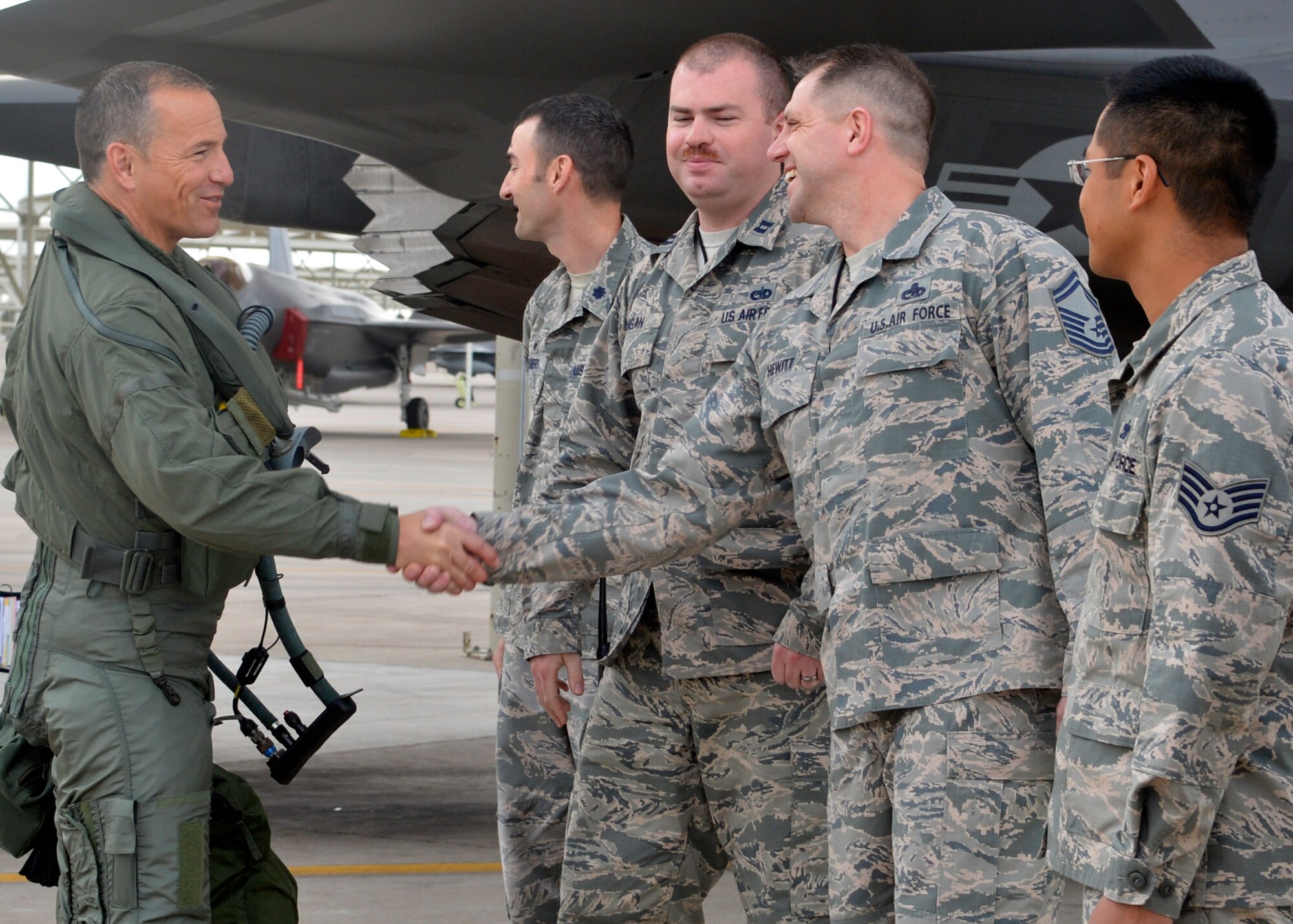 Brig. Gen. Scott Pleus, 56th Fighter Wing commander, greets the ground crew that will launch him during his first F-35 sortie flight at Luke Air Force Base, Ariz., March 18, 2015. (U.S. Air Force photo/Senior Airman Devante Williams)
