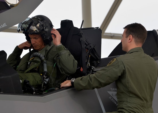 Brig. Gen. Scott Pleus, 56th Fighter Wing commander, places on the helmet during his first F-35 sortie flight at Luke Air Force Base, Ariz., March 18, 2015.  (U.S. Air Force photo/Senior Airman Devante Williams)